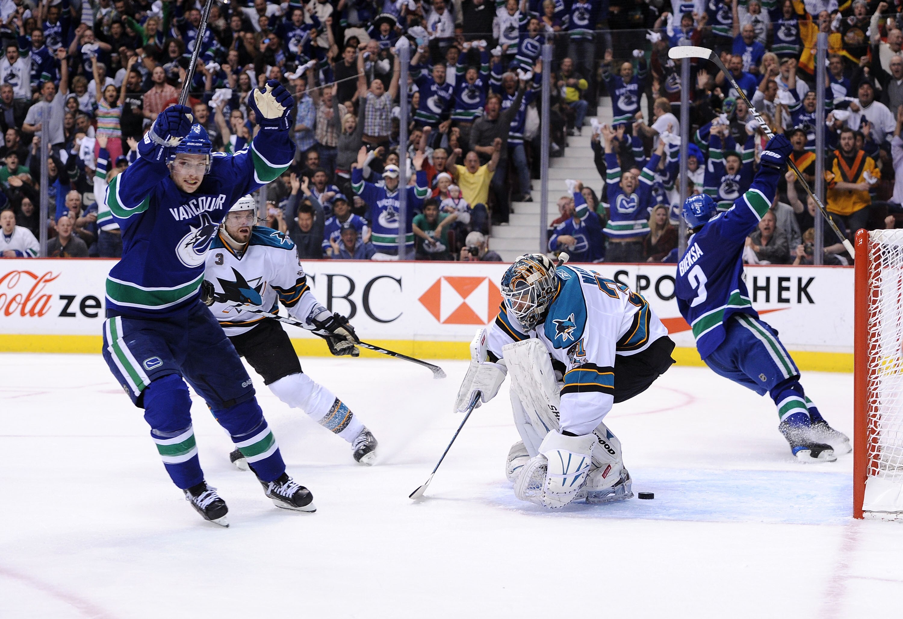 VANCOUVER, CANADA - MAY 18:  Mason Raymond #21 and Kevin Bieksa #3 of the Vancouver Canucks react Bieksa scored a goal against Antti Niemi #31 of the San Jose Sharks in the second period in Game Two of the Western Conference Finals during the 2011 Stanley