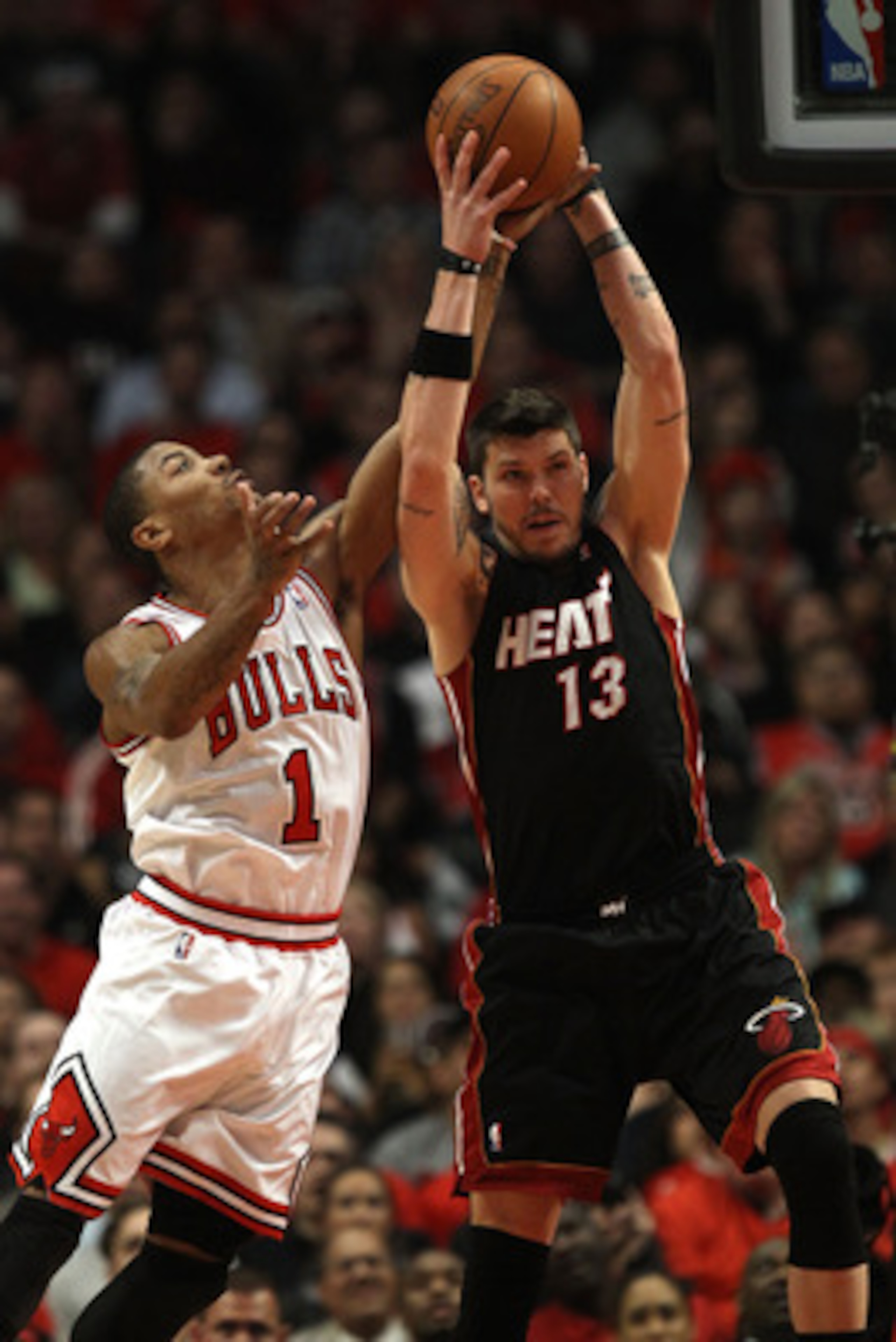 CHICAGO, IL - MAY 15:  Mike Miller #13 of the Miami Heat grabs a rebound against Derrick Rose #1 of the Chicago Bulls in Game One of the Eastern Conference Finals during the 2011 NBA Playoffs on May 15, 2011 at the United Center in Chicago, Illinois. The