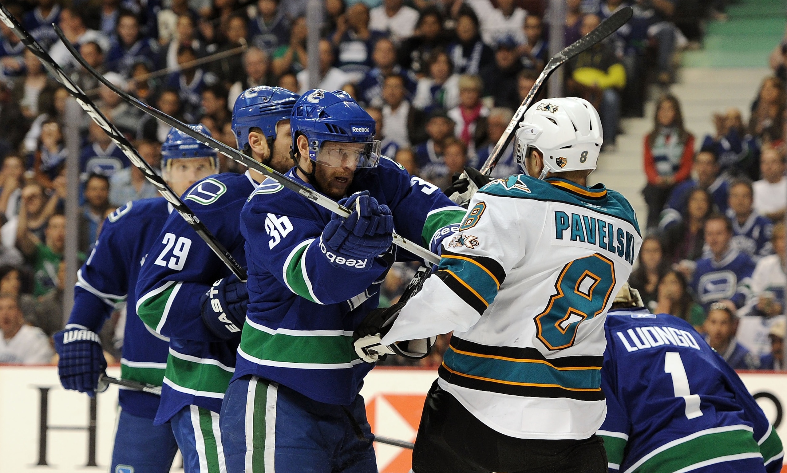 VANCOUVER, CANADA - MAY 18: Jannik Hansen #36 of the Vancouver Canucks pushes Joe Pavelski #8 of the San Jose Sharks in the crease area after the whistle in the first in Game Two of the Western Conference Finals during the 2011 Stanley Cup Playoffs at Ro VANCOUVER, CANADA - MAY 18: Jannik Hansen #36 of the Vancouver Canucks pushes Joe Pavelski #8 of the San Jose Sharks in the crease area after the whistle in the first in Game Two of the Western Conference Finals during the 2011 Stanley Cup Playoffs at Ro