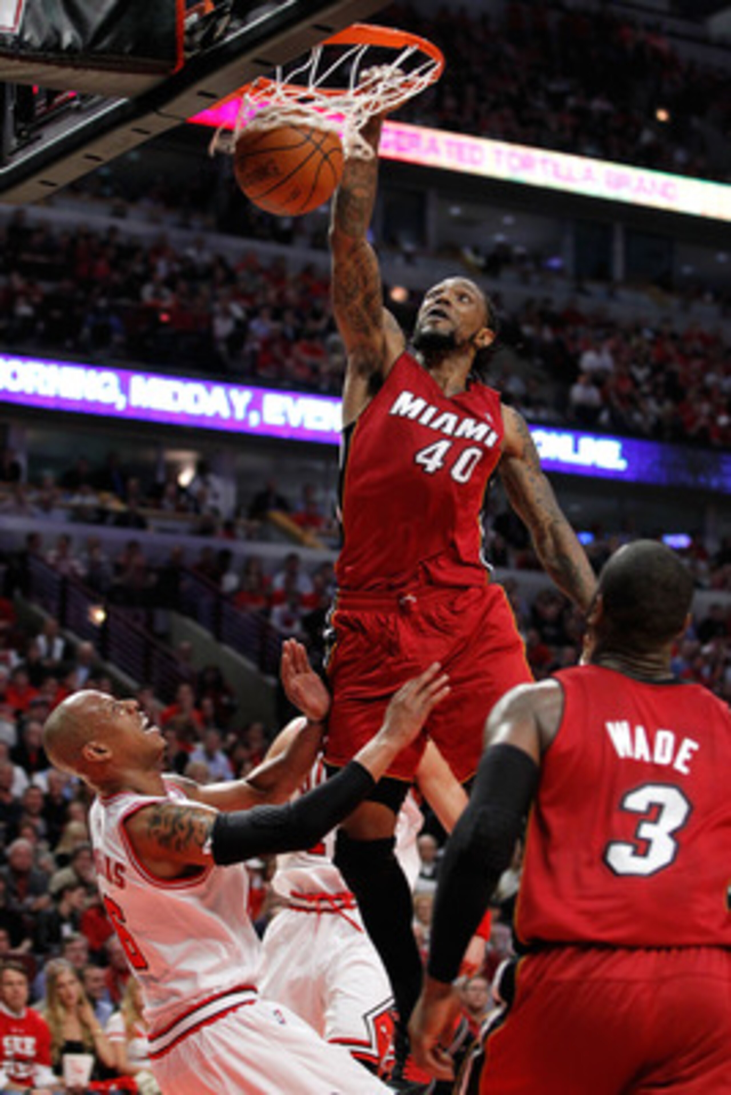 CHICAGO, IL - MAY 18:  Udonis Haslem #40 of the Miami Heat dunks against Keith Bogans #6 of the Chicago Bulls in Game Two of the Eastern Conference Finals during the 2011 NBA Playoffs on May 18, 2011 at the United Center in Chicago, Illinois. NOTE TO USER