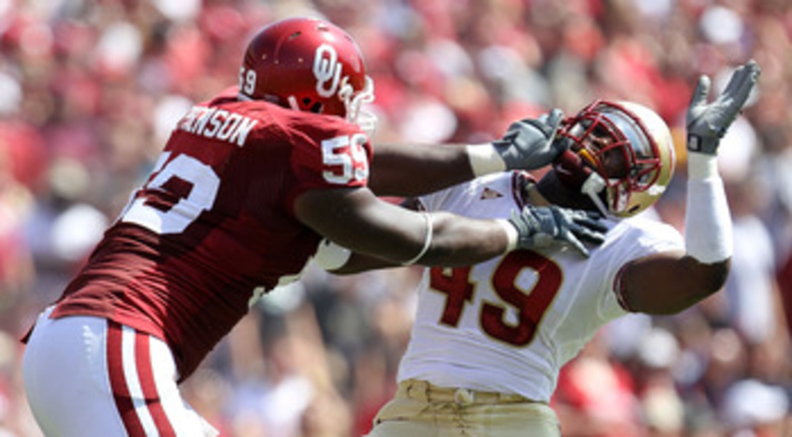 NORMAN, OK - SEPTEMBER 11:  Offensive lineman Donald Stephenson #59 of the Oklahoma Sooners grabs the facemask of Brandon Jenkins #49 of the Florida State Seminoles at Gaylord Family Oklahoma Memorial Stadium on September 11, 2010 in Norman, Oklahoma.  (P