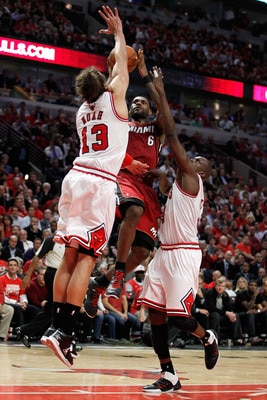 CHICAGO, IL - MAY 18:  LeBron James #6 of the Miami Heat drives for a shot attempt against Mike Miller #13 and Luol Deng #9 of the Chicago Bulls in Game Two of the Eastern Conference Finals during the 2011 NBA Playoffs on May 18, 2011 at the United Center