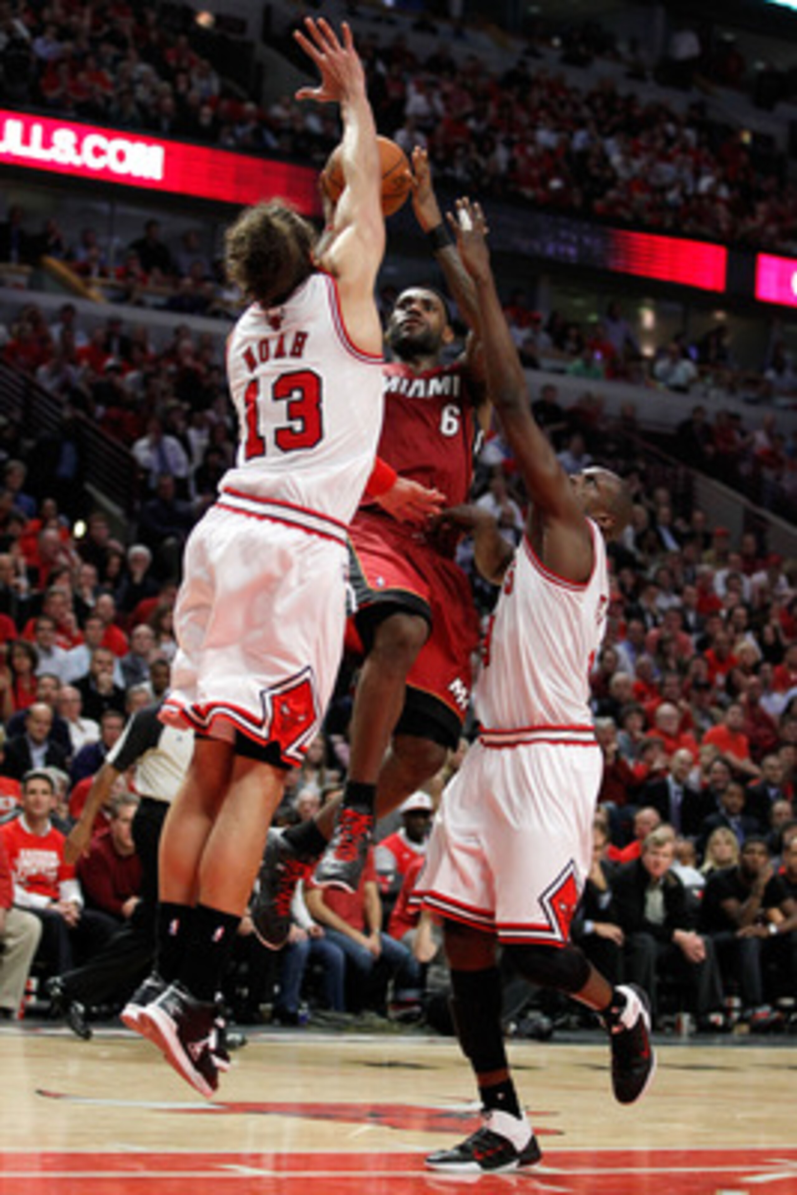 CHICAGO, IL - MAY 18:  LeBron James #6 of the Miami Heat drives for a shot attempt against Mike Miller #13 and Luol Deng #9 of the Chicago Bulls in Game Two of the Eastern Conference Finals during the 2011 NBA Playoffs on May 18, 2011 at the United Center