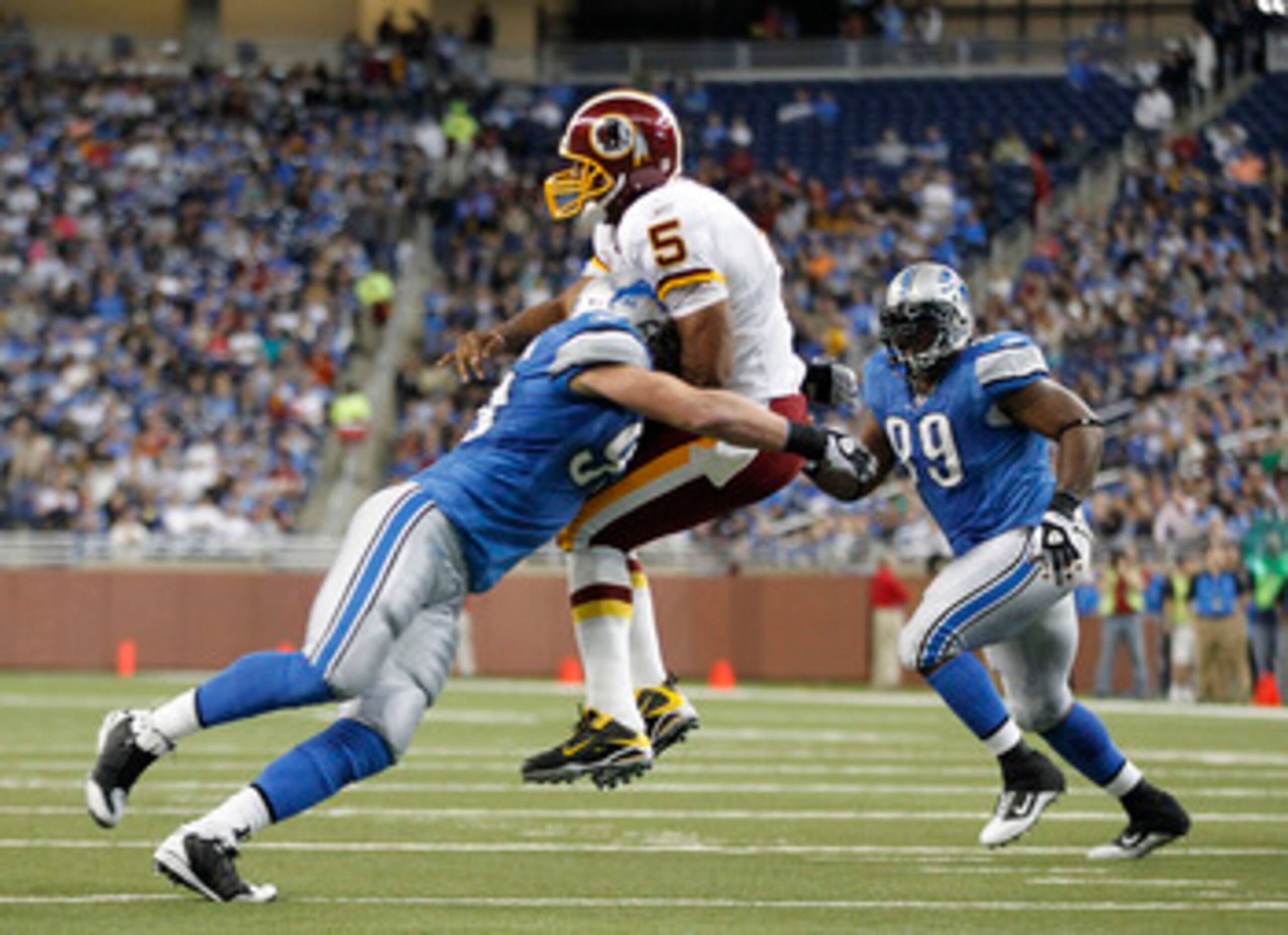 DETROIT - OCTOBER 31: Kyle Vanden Bosch #93 of the Detroit Lions hits Donovan McNabb #5 of the Washington Redskins during the first quarter of the game at Ford Field on October 31, 2010 in Detroit, Michigan. (Photo by Leon Halip/Getty Images)
