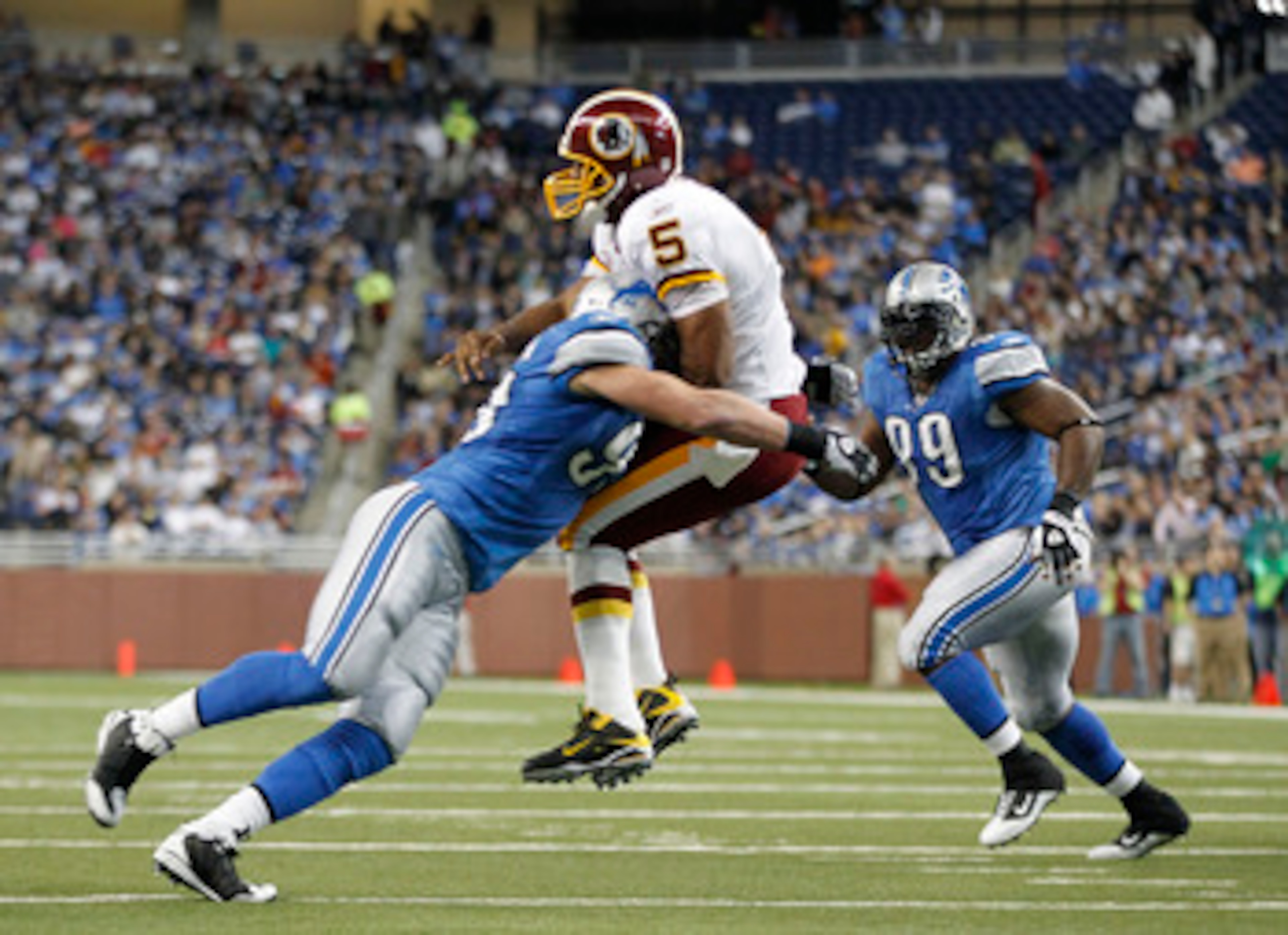DETROIT - OCTOBER 31: Kyle Vanden Bosch #93 of the Detroit Lions hits Donovan McNabb #5 of the Washington Redskins during the first quarter of the game at Ford Field on October 31, 2010 in Detroit, Michigan. (Photo by Leon Halip/Getty Images)