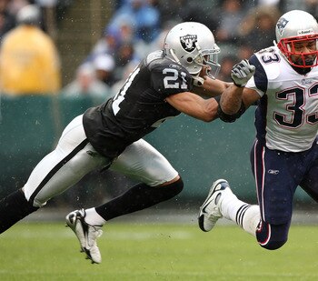 OAKLAND, CA - DECEMBER 14: Kevin Faulk #33 of the New England Patriots runs with the ball as Nnamdi Asomugha #21 of the Oakland Raiders defends during an NFL game on December 14, 2008 at the Oakland-Alameda County Coliseum in Oakland, California.  (Photo