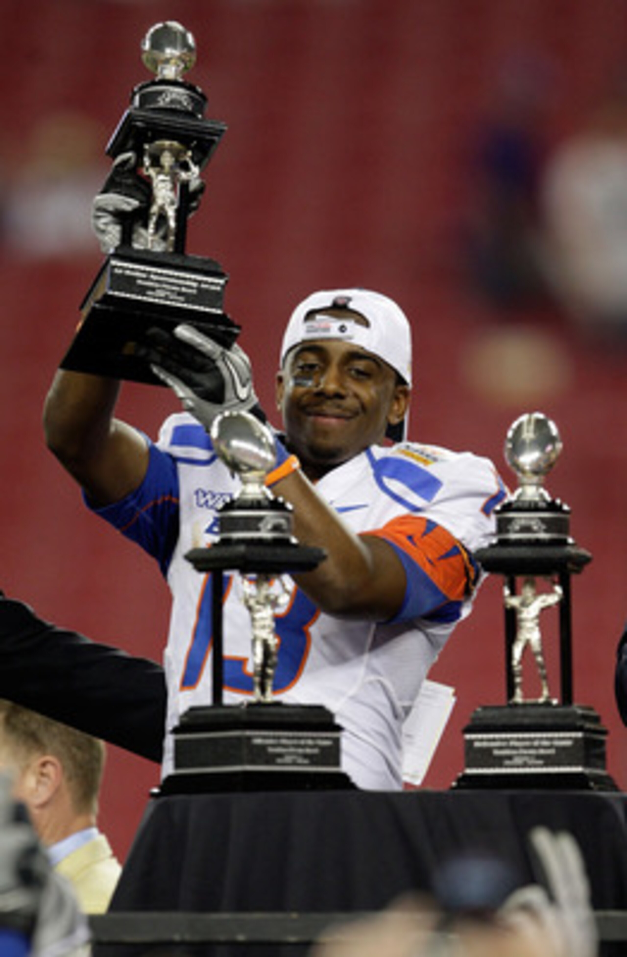 GLENDALE, AZ - JANUARY 04:  Brandyn Thompson #13 of the Boise State Broncos celebrates with the defensive MVP trophy after defeating the TCU Horned Frogs 17-10 during the Tostitos Fiesta Bowl at the Universtity of Phoenix Stadium on January 4, 2010 in Gle