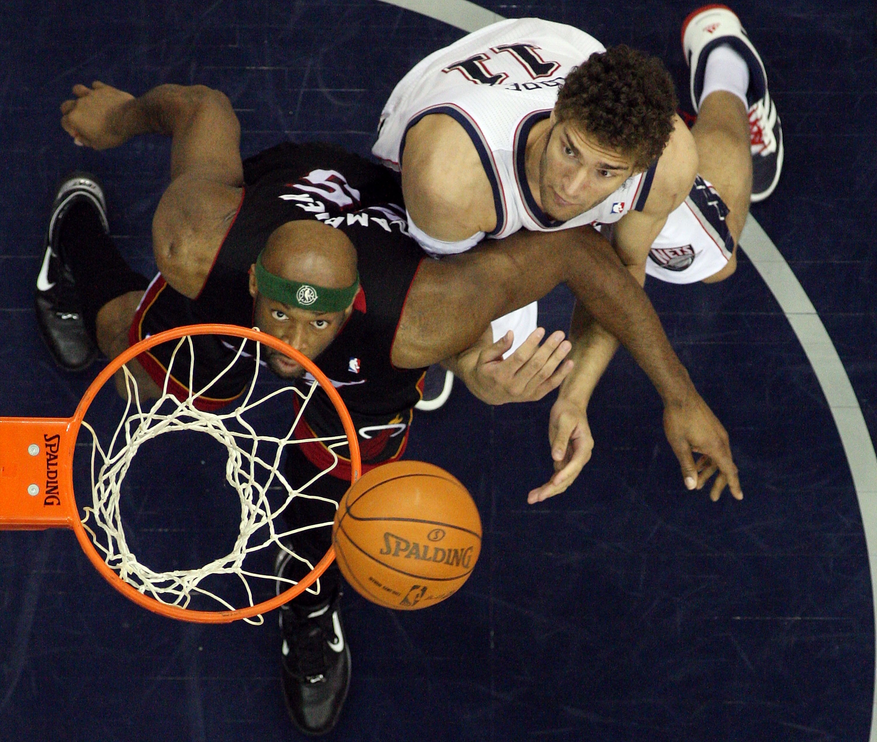 NEWARK, NJ - APRIL 03:  Eric Dampier #25 of the Miami Heat and Brook Lopez #11 of the New Jersey Nets battle for rebound at the Prudential Center on April 3, 2011 in Newark, New Jersey.The Heat defeated the Nets 108-94.NOTE TO USER: User expressly acknowl