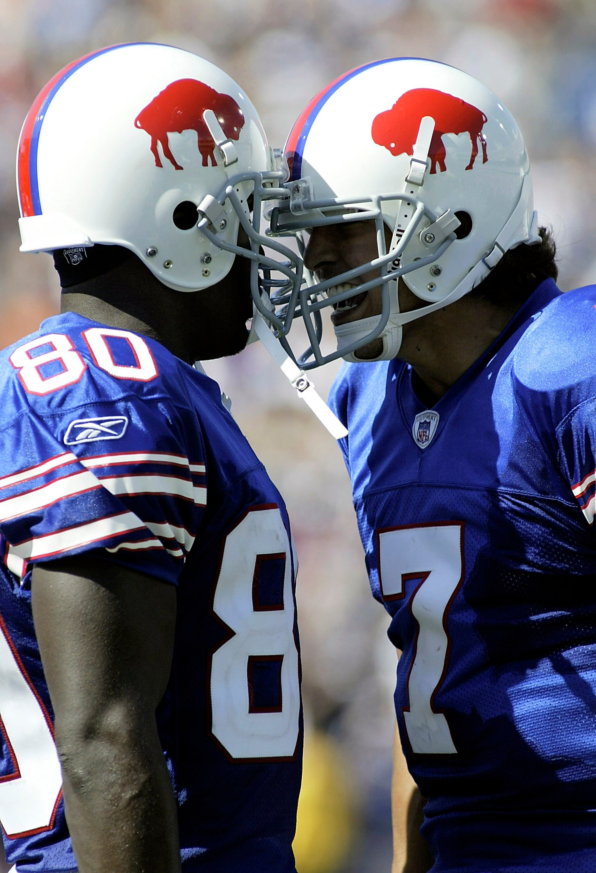 ORCHARD PARK, NY - SEPTEMBER 11: JP Losman #7 and Eric Moulds #80 of the Buffalo Bills butt helmets after Losman threw his first career touchdown pass against the Houston Texans on September 11, 2005 at Ralph Wilson Stadium in Orchard Park, New York.(Phot