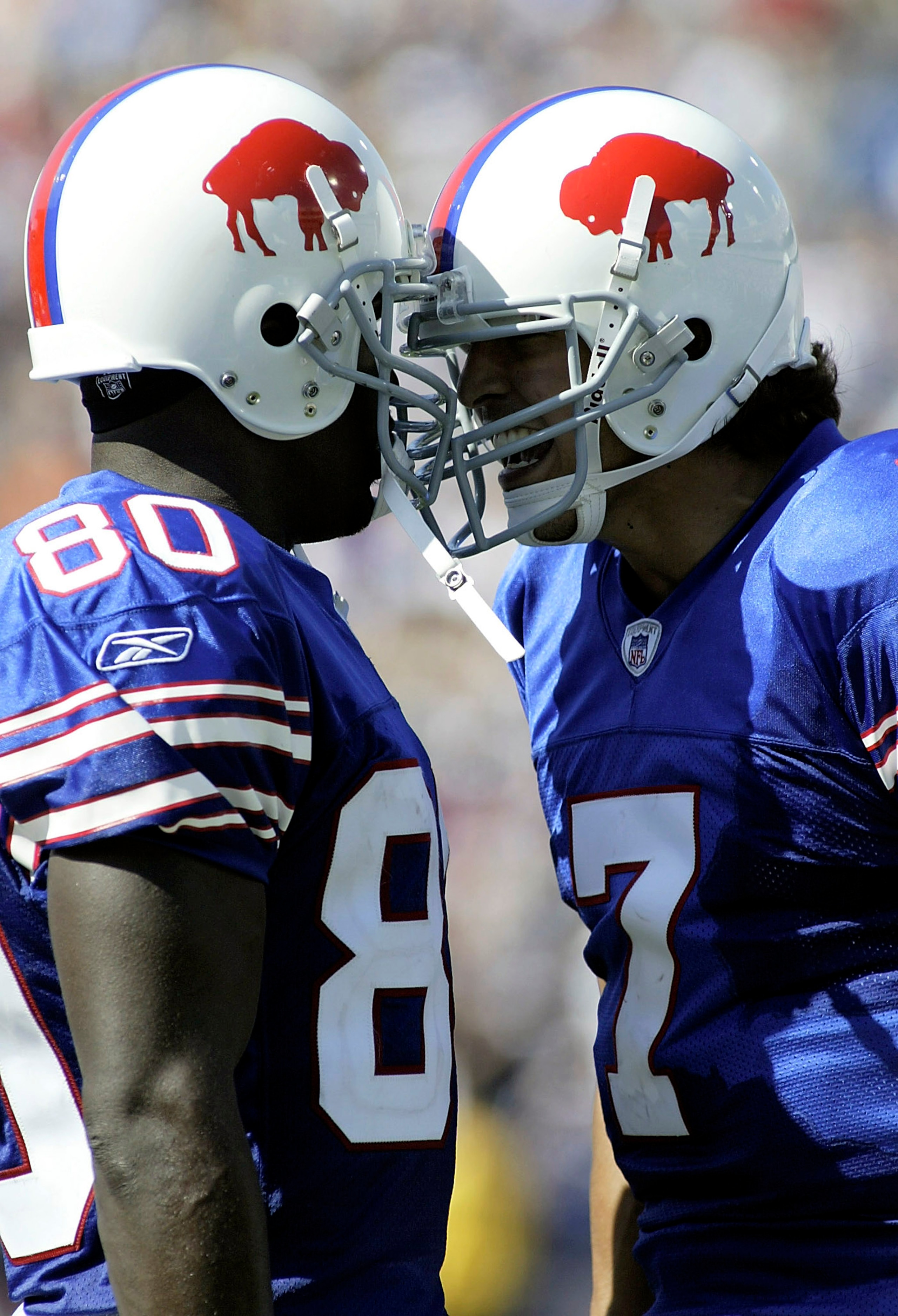 ORCHARD PARK, NY - SEPTEMBER 11: JP Losman #7 and Eric Moulds #80 of the Buffalo Bills butt helmets after Losman threw his first career touchdown pass against the Houston Texans on September 11, 2005 at Ralph Wilson Stadium in Orchard Park, New York.(Phot