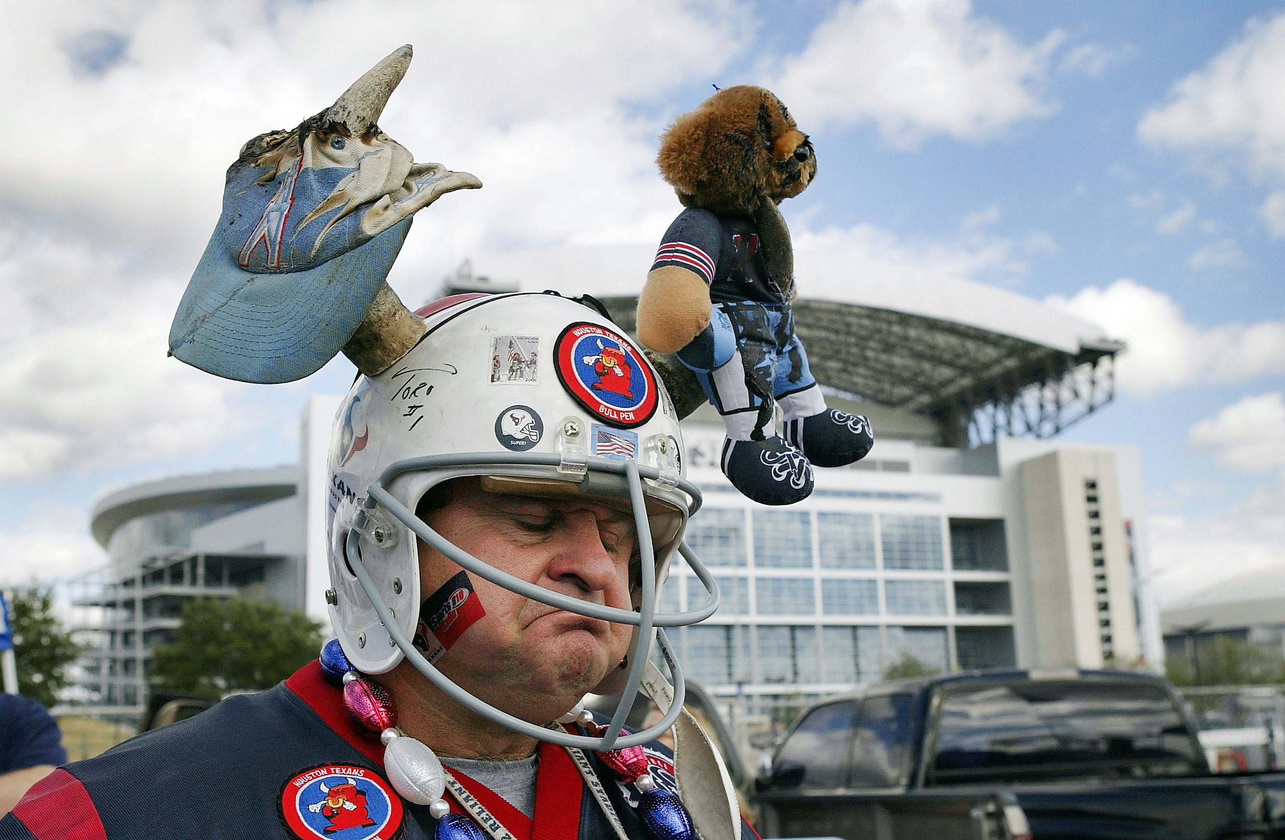 HOUSTON - DECEMBER 21:  Houston Texans fan Preston Chauvin wears a helmet with a Houston Oilers hat speared onto it as he chats with fans before a game against the Tennessee Titans December 21, 2003 outside Reliant Stadium and the Astrodome in Houston, Te