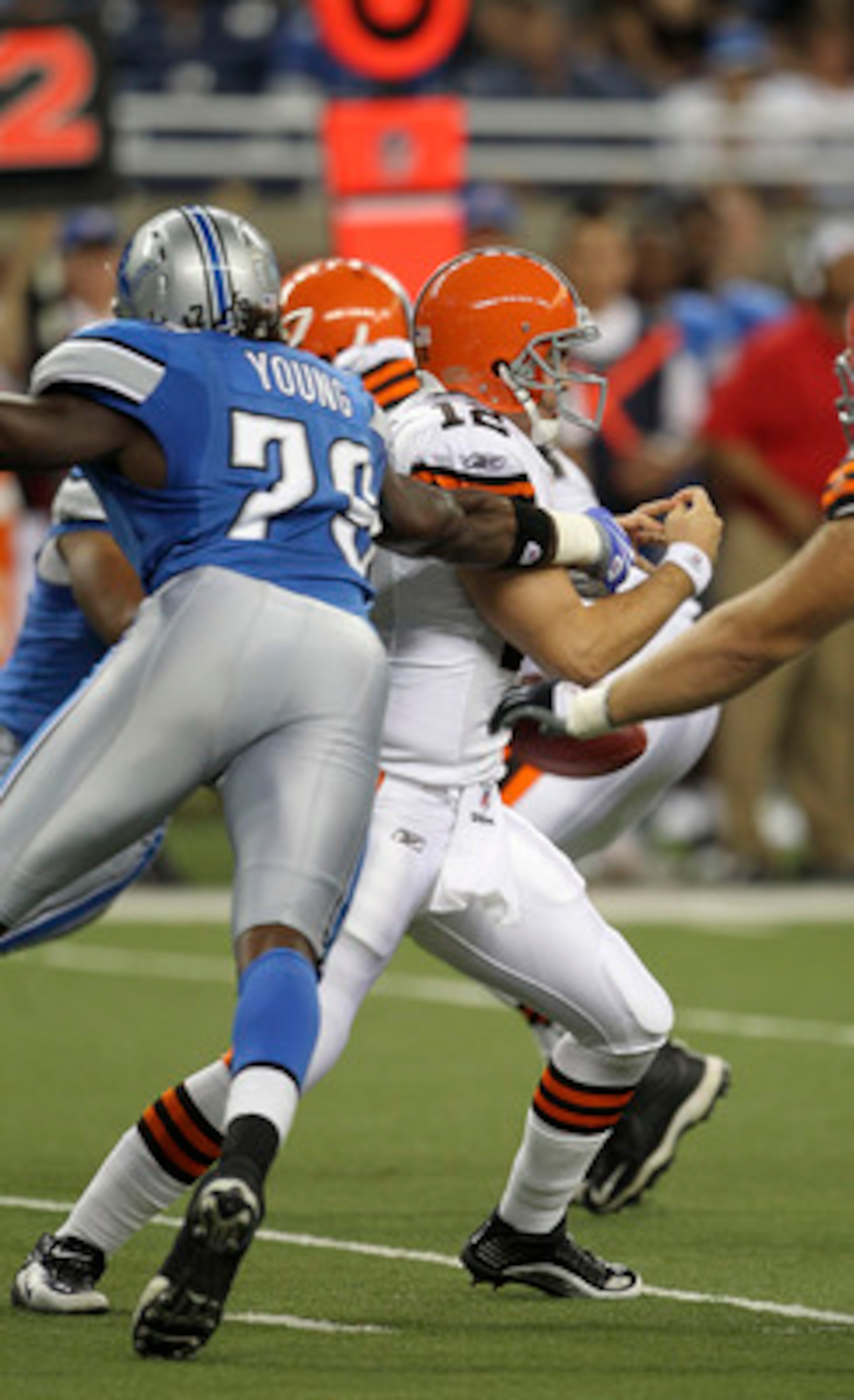 DETROIT - AUGUST 28: Willie Young #79 of the Detroit Lions slaps the ball away from Colt McCoy #12 of the Cleveland Browns during the fourth quarter of the preseason game at Ford Field on August 28, 2010 in Detroit, Michigan. The Lions defeated the Browns