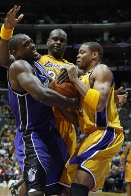 LOS ANGELES - APRIL 10:  Chris Webber #4 of the Sacramento Kings comes under pressure from Devean George #3 and Shaquille O'Neal #34 of the Los Angeles Lakers during the game on April 4, 2003 at Staples Center in Los Angeles, California.  The Lakers won 1