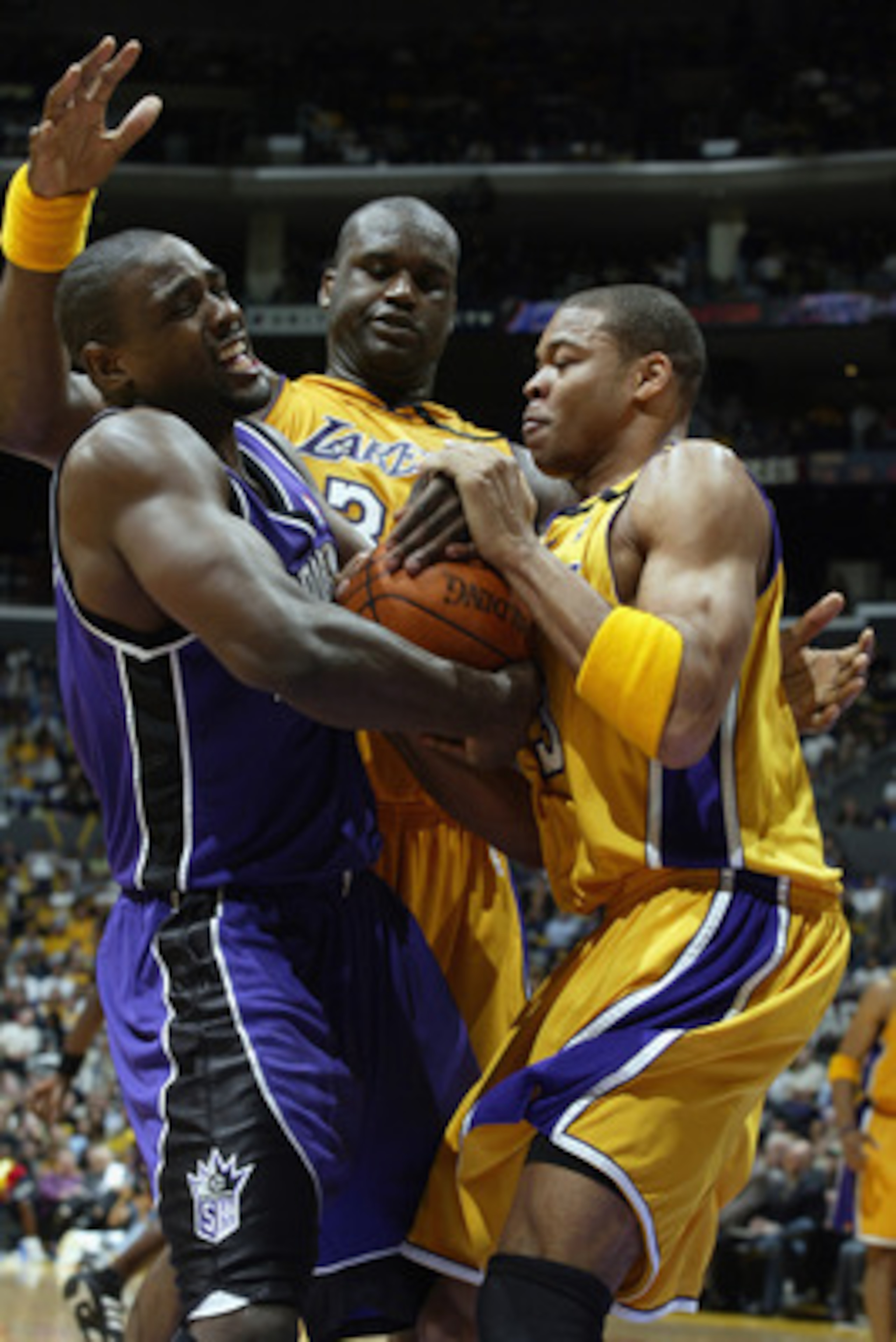 LOS ANGELES - APRIL 10: Chris Webber #4 of the Sacramento Kings comes under pressure from Devean George #3 and Shaquille O'Neal #34 of the Los Angeles Lakers during the game on April 4, 2003 at Staples Center in Los Angeles, California. The Lakers won 1 LOS ANGELES - APRIL 10: Chris Webber #4 of the Sacramento Kings comes under pressure from Devean George #3 and Shaquille O'Neal #34 of the Los Angeles Lakers during the game on April 4, 2003 at Staples Center in Los Angeles, California. The Lakers won 1
