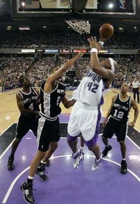 SACRAMENTO, CA - MAY 5:  Bonzi Wells #42 of the Sacramento Kings shoots over Tim Duncan #21 of the San Antonio Spurs in game six of the Western Conference Quarterfinals during the 2006 NBA Playoffs on May 5, 2006 at ARCO Arena in Sacramento, California.  