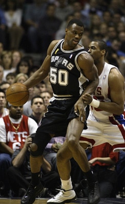 EAST RUTHERFORD, NJ - JUNE 13:  David Robinson #50 of the San Antonio Spurs is defended by Jason Collins #35 of the New Jersey Nets in game five of the 2003 NBA Finals on June 13, 2003 at the Continental Airlines Arena in East Rutherford, New Jersey.  The
