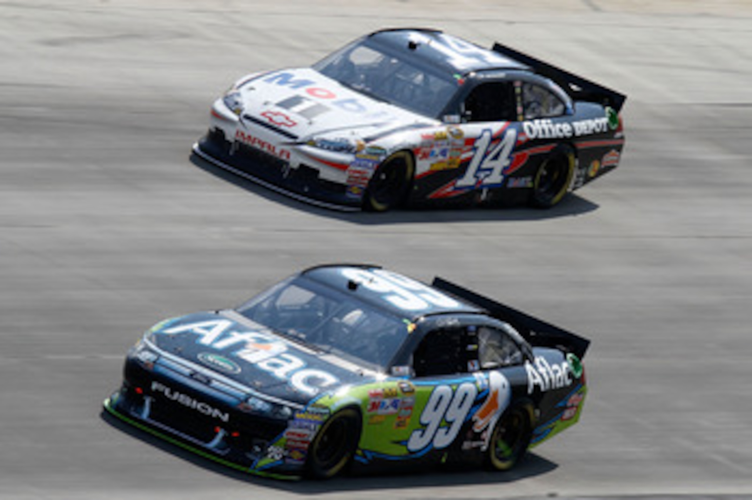 DOVER, DE - MAY 15:  Carl Edwards, driver of the #99 Aflac Ford, races Tony Stewart, driver of the #14 Mobil 1/Office Depot Chevrolet, during the NASCAR Sprint Cup Series FedEx 400 Benefiting Autism Speaks at Dover International Speedway on May 15, 2011 i