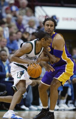 MINNEAPOLIS - MAY 29:  Latrell Sprewell #8 of the Minnesota Timberwolves drives around Rick Fox #17 of the Los Angeles Lakers in Game five of the Western Conference Finals during the 2004 NBA Playoffs at Target Center on May 29, 2004 in Minneapolis, Minne