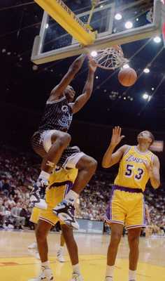 Orlando Magic center Shaquille O''Neal slam dunks over the Lakers'' James Edwards during the ''92-''93 season. Mandatory Credit: Ken Levine/ALLSPORT