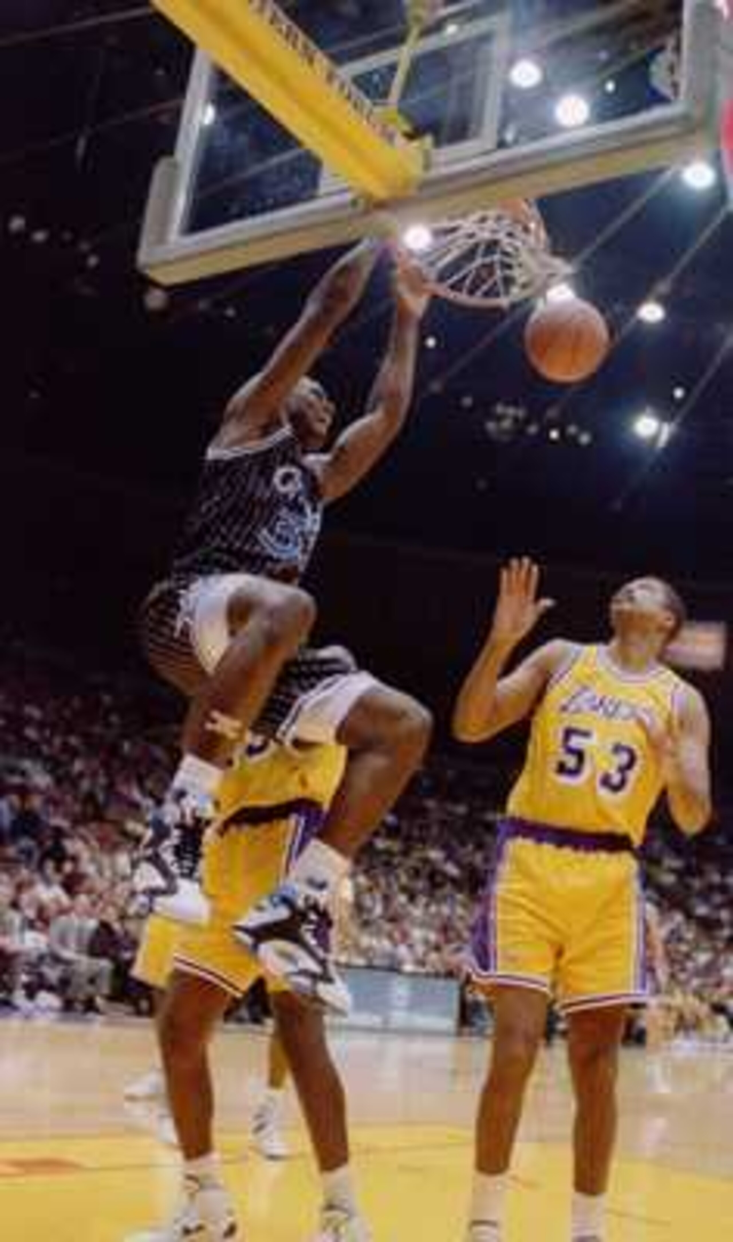 Orlando Magic center Shaquille O''Neal slam dunks over the Lakers'' James Edwards during the ''92-''93 season. Mandatory Credit: Ken Levine/ALLSPORT