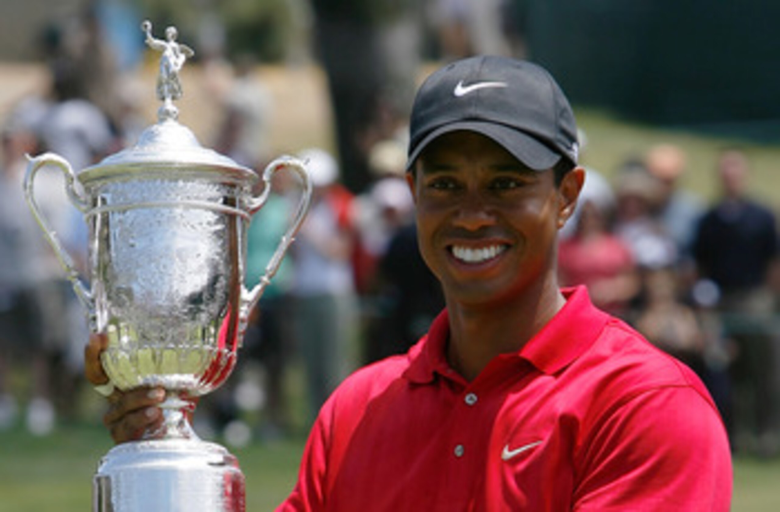 SAN DIEGO - JUNE 16:  Tiger Woods celebrates with the trophy after winning on the first sudden death playoff hole during the playoff round of the 108th U.S. Open at the Torrey Pines Golf Course (South Course) on June 16, 2008 in San Diego, California.  (P