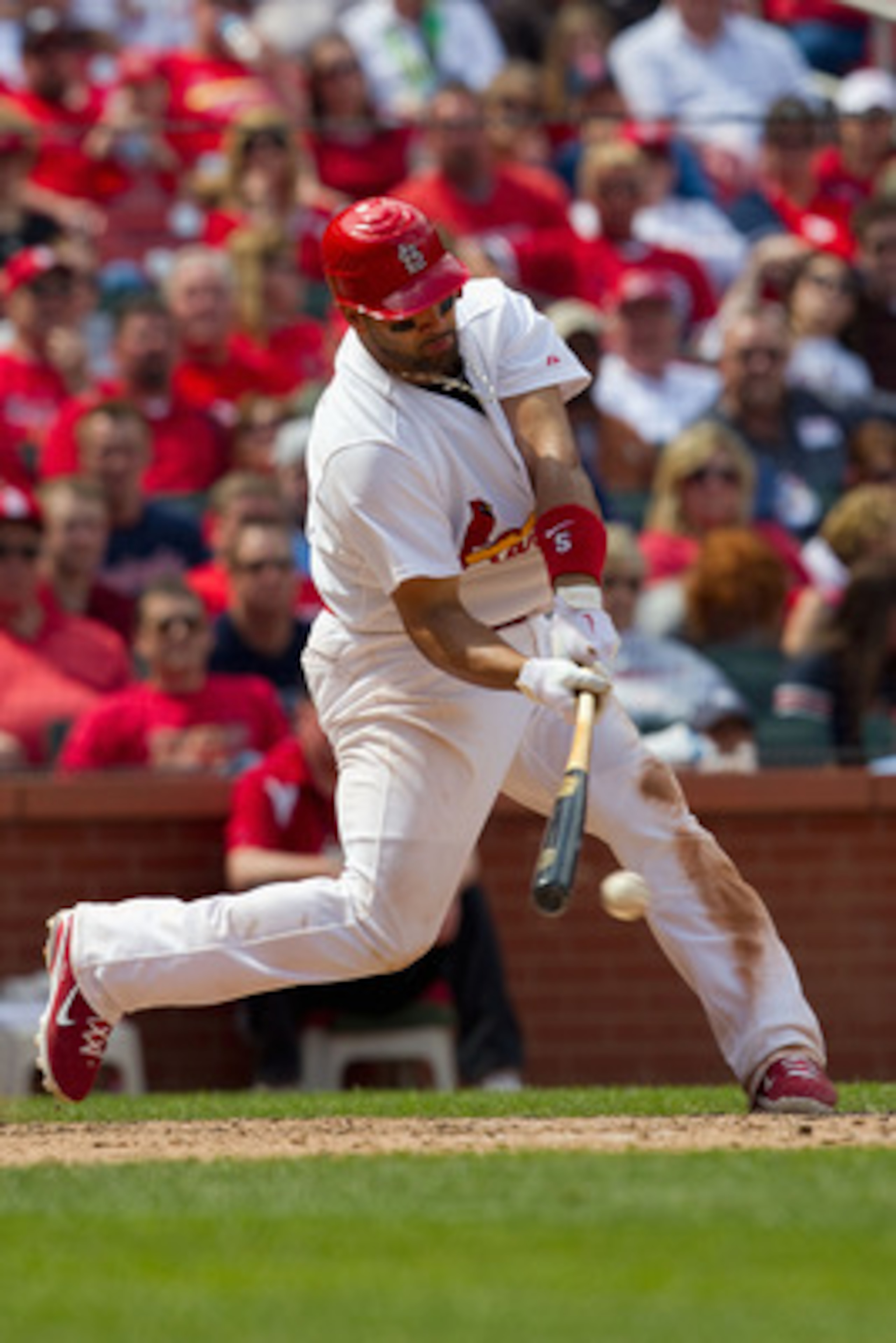 ST. LOUIS, MO - MAY 5: Albert Pujols #5 of the St. Louis Cardinals hits a single against the Florida Marlins at Busch Stadium on May 5, 2011 in St. Louis, Missouri.  (Photo by Dilip Vishwanat/Getty Images)