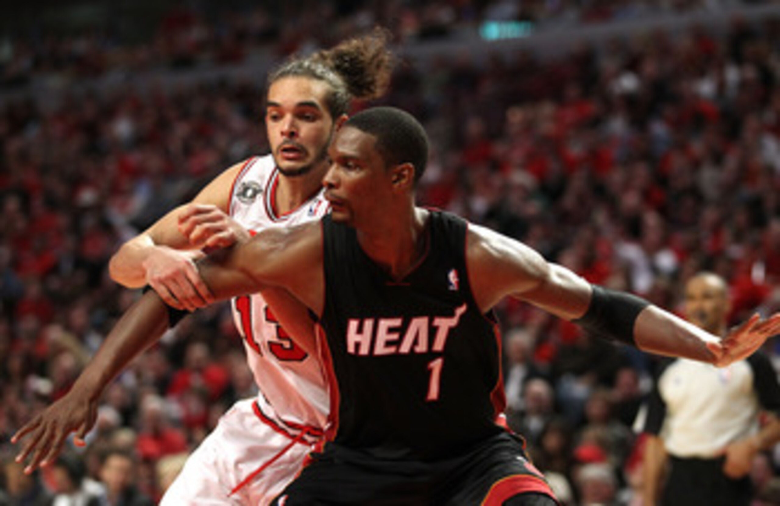 CHICAGO, IL - MAY 15:  Joakim Noah #13 of the Chicago Bulls fights for rebound position against Chris Bosh #1 of the Miami Heat in Game One of the Eastern Conference Finals during the 2011 NBA Playoffs on May 15, 2011 at the United Center in Chicago, Illi