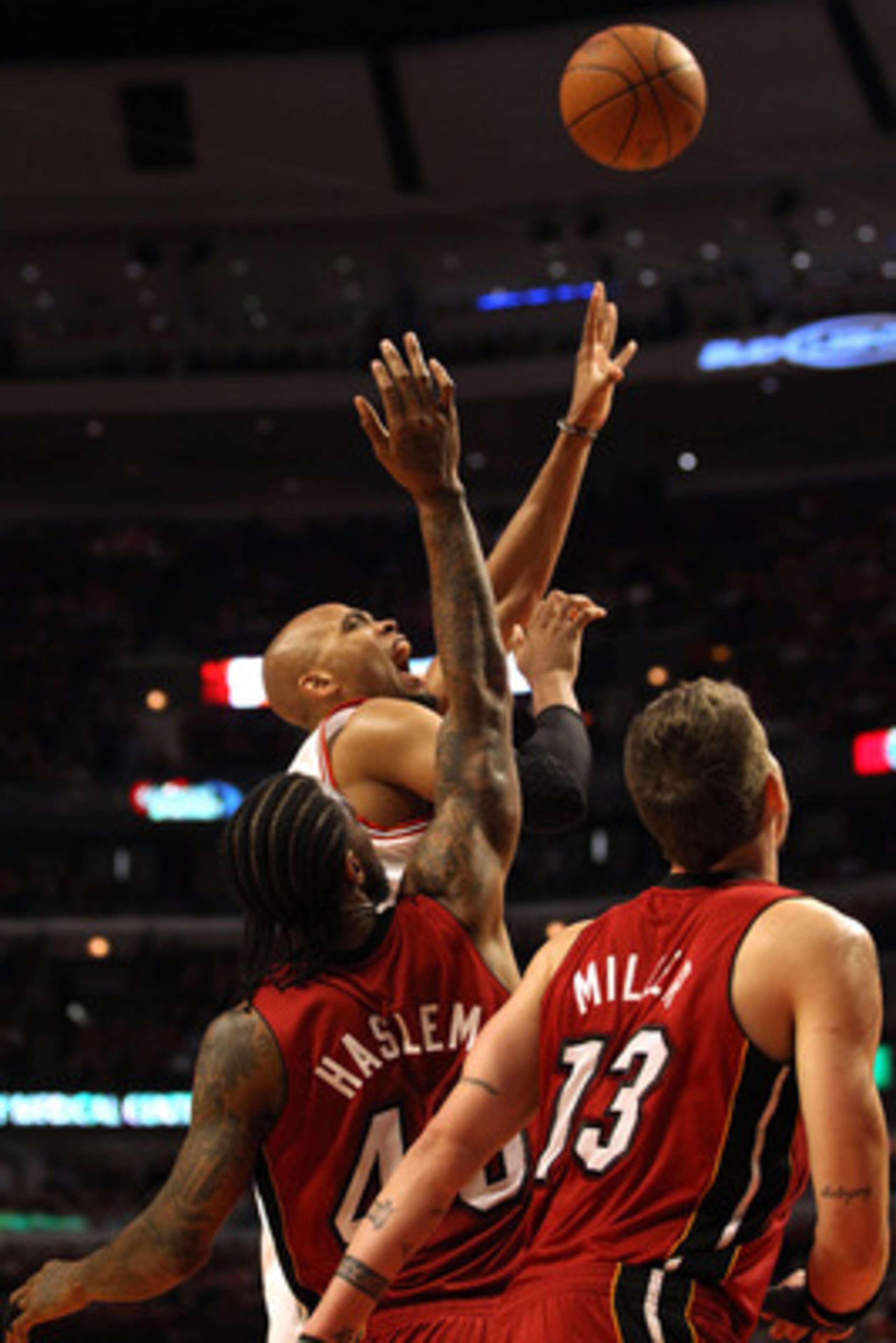 CHICAGO, IL - MAY 18:  Taj Gibson #22 of the Chicago Bulls attempts a shot against Udonis Haslem #40 and Mike Miller #13 of the Miami Heat in Game Two of the Eastern Conference Finals during the 2011 NBA Playoffs on May 18, 2011 at the United Center in Ch