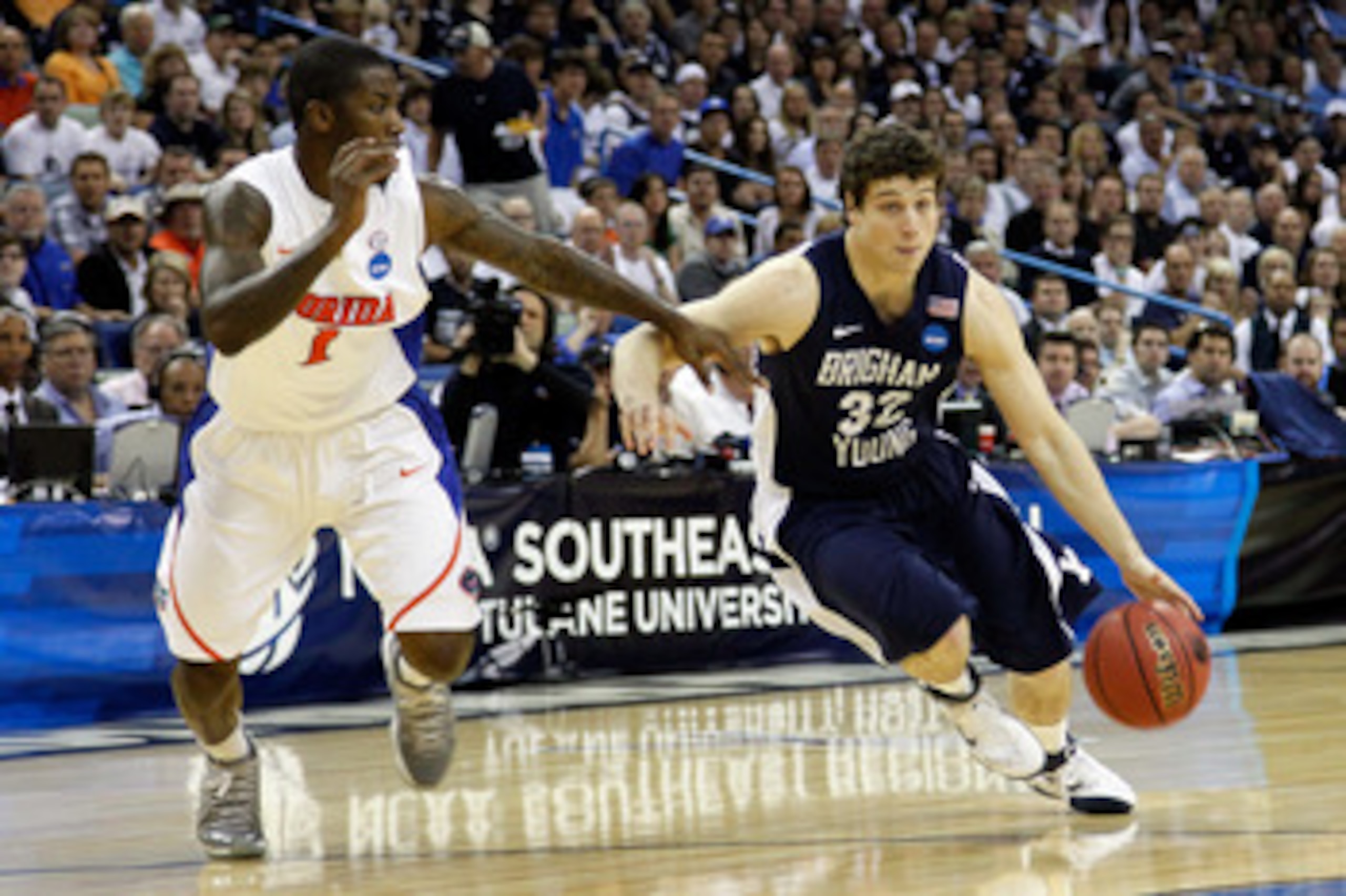 NEW ORLEANS, LA - MARCH 24:  Jimmer Fredette #32 of the Brigham Young Cougars drives against Kenny Boynton #1 of the Florida Gators during the Southeast regional of the 2011 NCAA men's basketball tournament at New Orleans Arena on March 24, 2011 in New Or