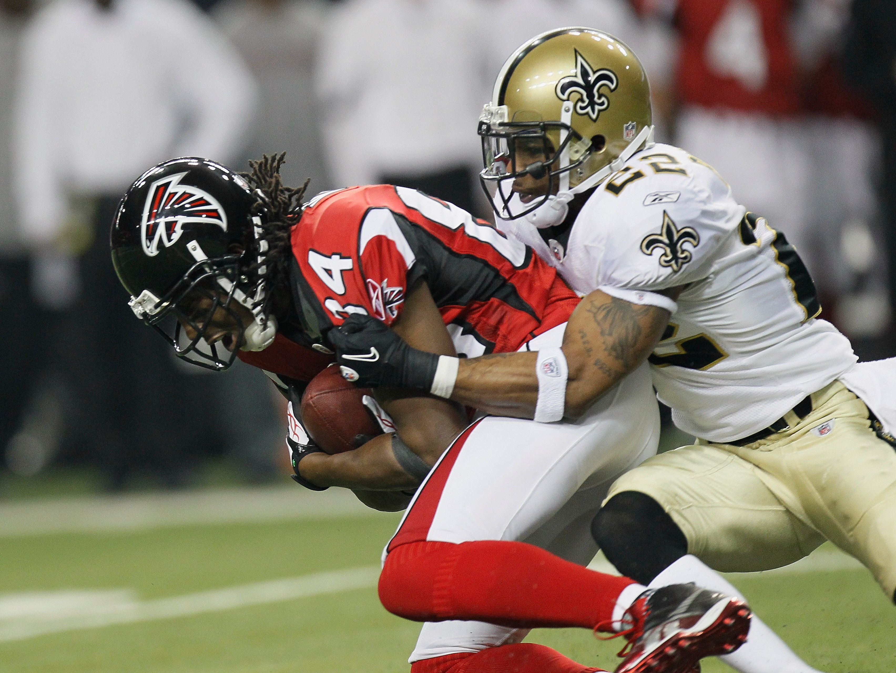 ATLANTA, GA - DECEMBER 27:  Roddy White #84 of the Atlanta Falcons fights off the tackle of Tracy Porter #22 of the New Orleans Saints during their game at the Georgia Dome on December 27, 2010 in Atlanta, Georgia.  (Photo by Kevin C. Cox/Getty Images)