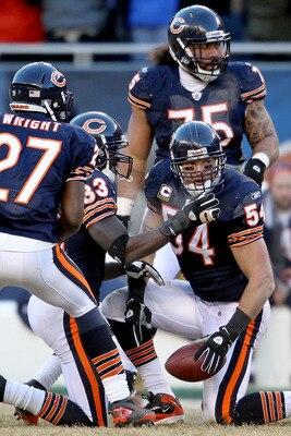 CHICAGO, IL - JANUARY 23:  Linebacker Brian Urlacher #54 of the Chicago Bears reacts with teammates after his 39-yard interception return against the Green Bay Packers in the NFC Championship Game at Soldier Field on January 23, 2011 in Chicago, Illinois.
