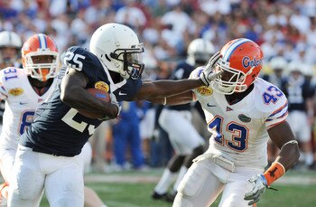 TAMPA, FL - JANUARY 1:  Running back Evan Royster #22 of the Penn State Nittany Lions pushed off linebacker Jelani Jenkins #43 of  the Florida Gators January 1, 2010 in the 25th Outback Bowl at Raymond James Stadium in Tampa, Florida.  (Photo by Al Messer