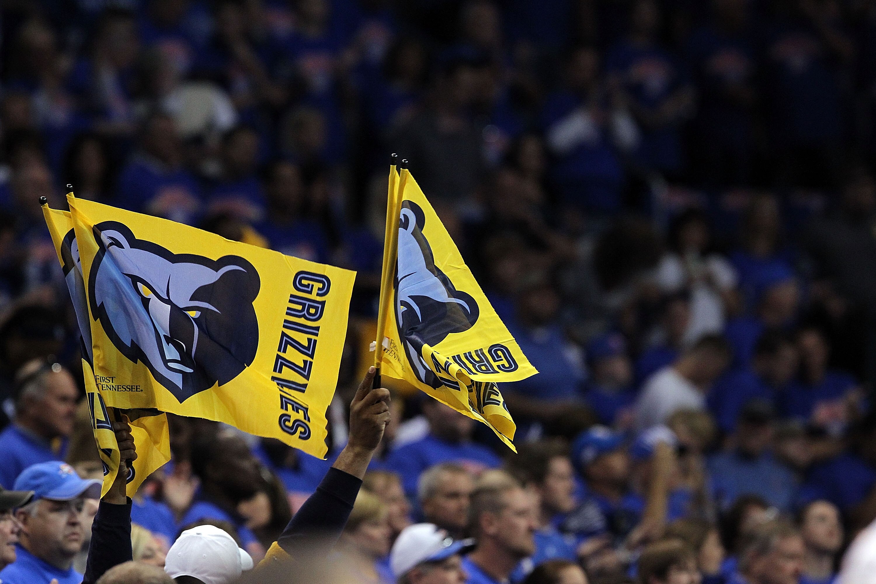 OKLAHOMA CITY, OK - MAY 15:  Fans of the Memphis Grizzlies waves flags against the Oklahoma City Thunder in Game Seven of the Western Conference Semifinals in the 2011 NBA Playoffs on May 15, 2011 at Oklahoma City Arena in Oklahoma City, Oklahoma.  NOTE T