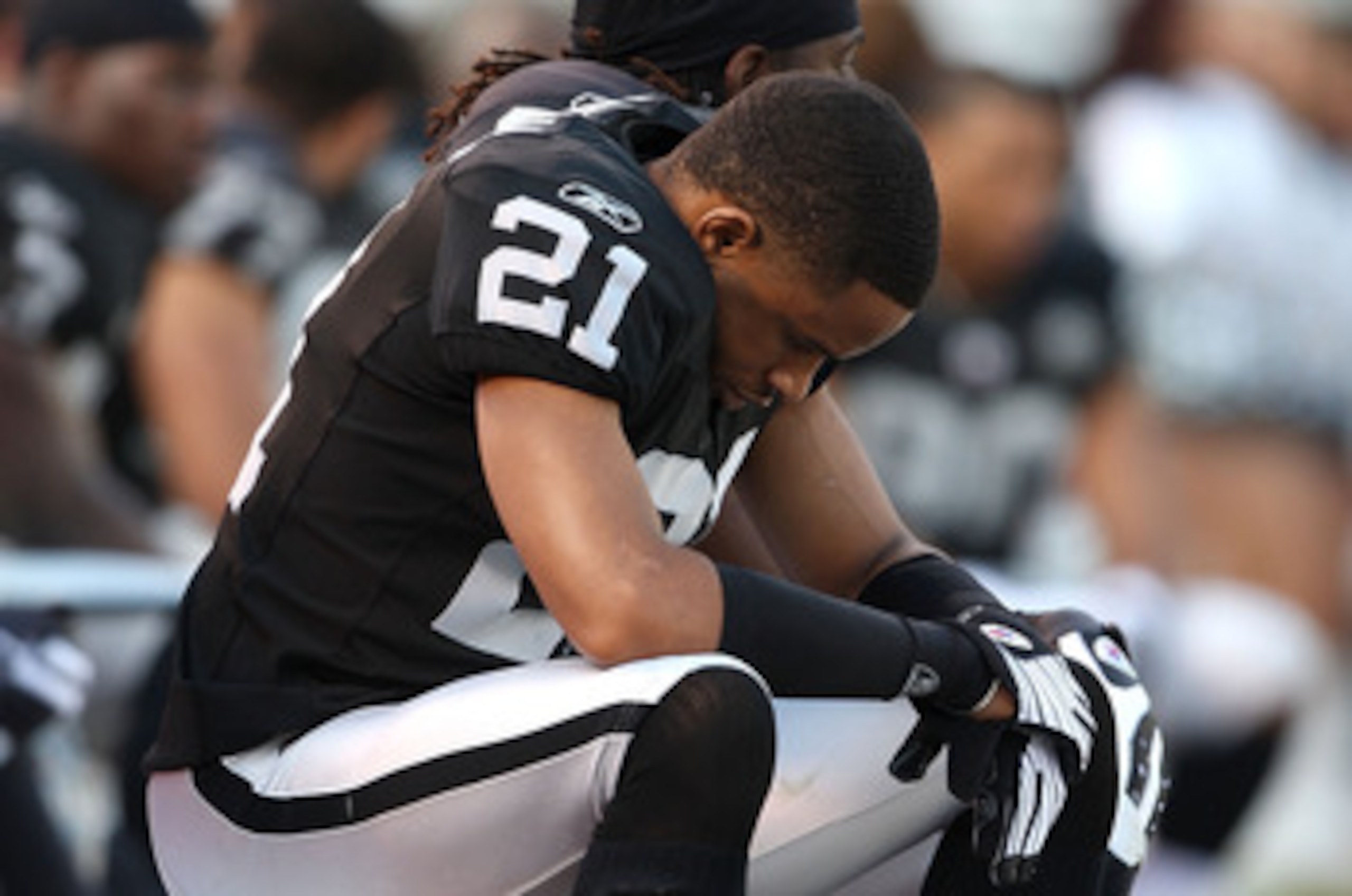 OAKLAND, CA - JANUARY 3: Nnamdi Asomugha #21 of the Oakland Raiders sits on the bench against the Baltimore Ravens during an NFL game at Oakland-Alameda County Coliseum on January 3, 2010 in Oakland, California. (Photo by Jed Jacobsohn/Getty Images) OAKLAND, CA - JANUARY 3: Nnamdi Asomugha #21 of the Oakland Raiders sits on the bench against the Baltimore Ravens during an NFL game at Oakland-Alameda County Coliseum on January 3, 2010 in Oakland, California. (Photo by Jed Jacobsohn/Getty Images)