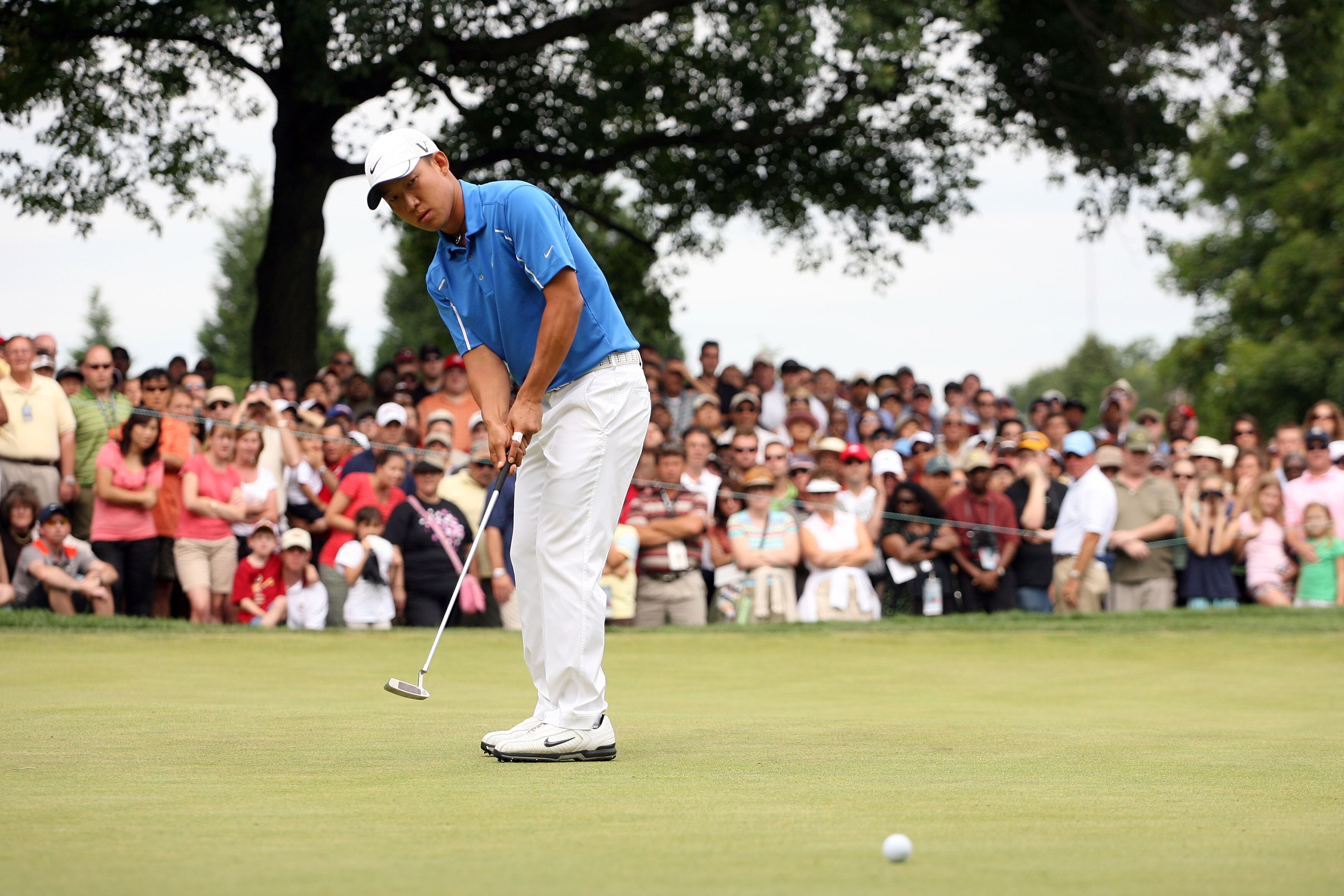 BETHESDA, MD - JULY 05:  Anthony Kim putts during the final round of the AT&T National hosted by Tiger Woods at Congressional Country Club on July 5, 2009 in Bethesda, Maryland.  (Photo by Hunter Martin/Getty Images)