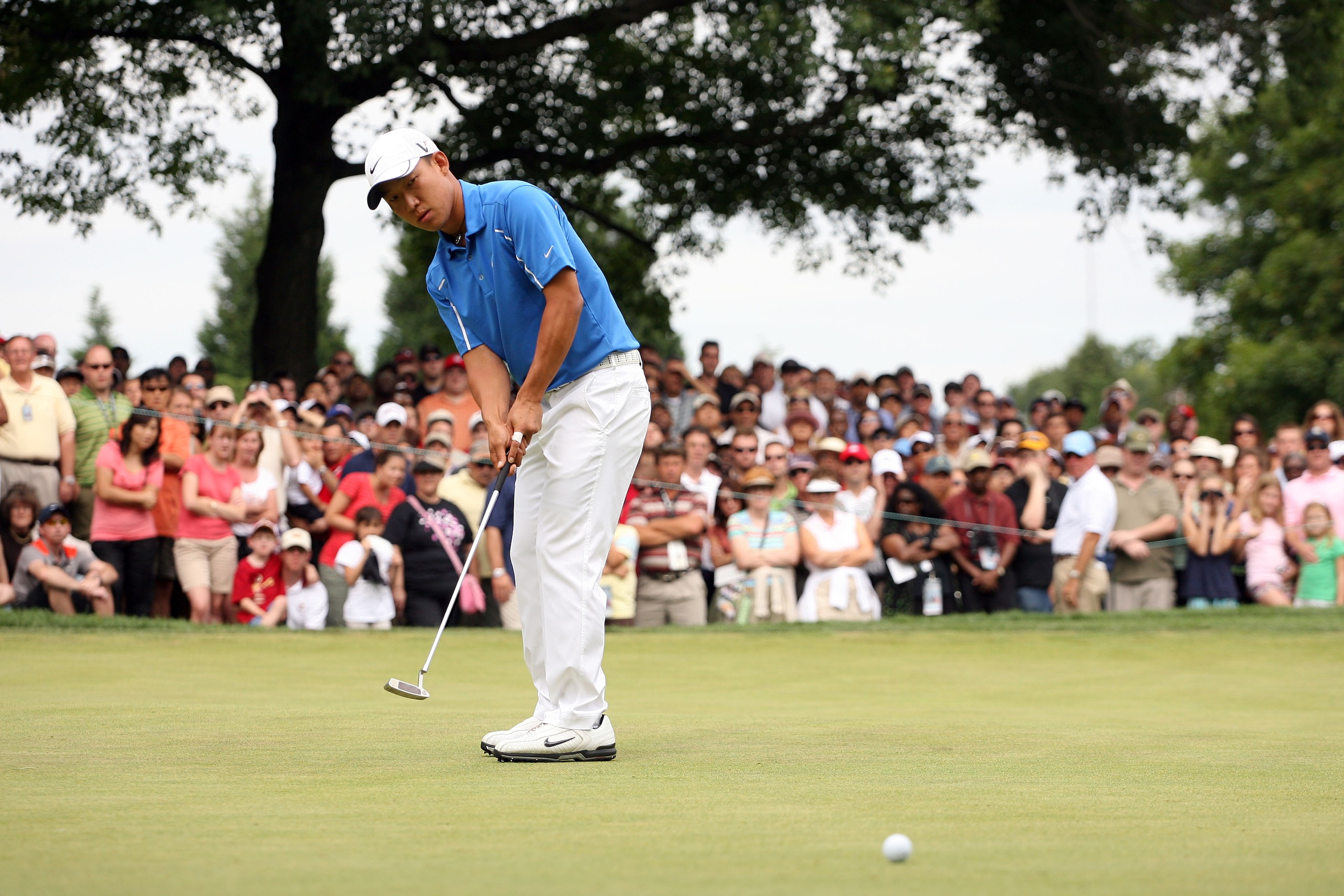 BETHESDA, MD - JULY 05:  Anthony Kim putts during the final round of the AT&T National hosted by Tiger Woods at Congressional Country Club on July 5, 2009 in Bethesda, Maryland.  (Photo by Hunter Martin/Getty Images)