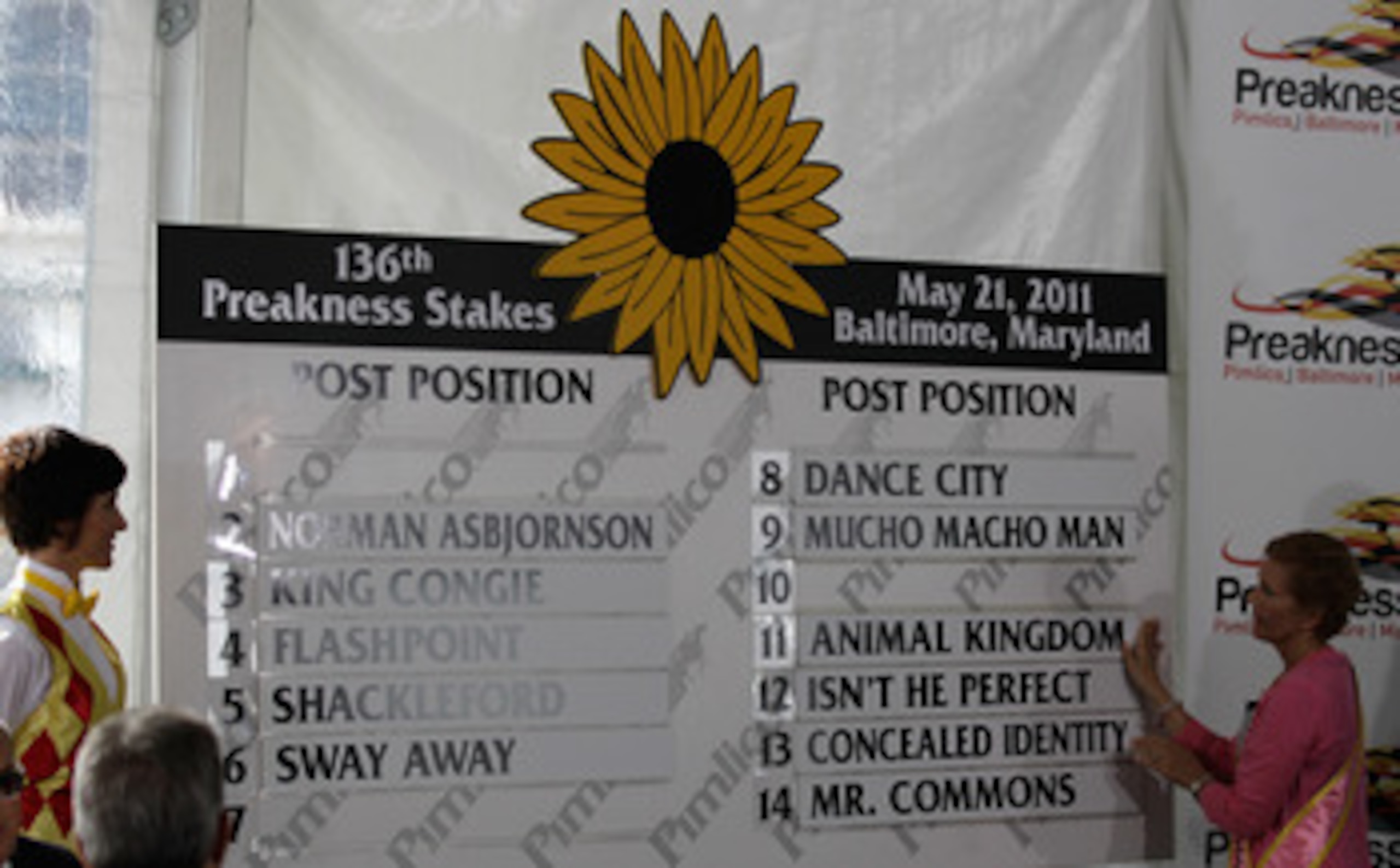 BALTIMORE, MD - MAY 18: Susan Faber (R) places the name of Kentucky Derby winner and Preakness entrant Animal Kingdom on the board during the post position draw for the 136th running of the Preakness Stakes at  Pimlico Race Course on May 18, 2011 in Balti