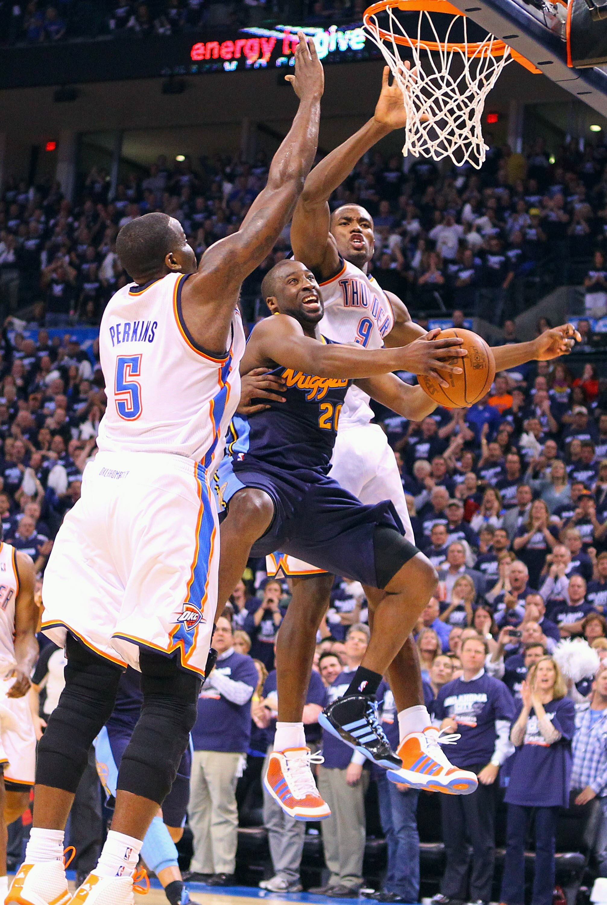 OKLAHOMA CITY, OK - APRIL 27: Raymond Felton #20 of the Denver Nuggets drives to the basket against Kendrick Perkins #5 and Serge Ibaka #9 \both of the Oklahoma City Thunder in Game Five of the Western Conference Quarterfinals in the 2011 NBA Playoffs on