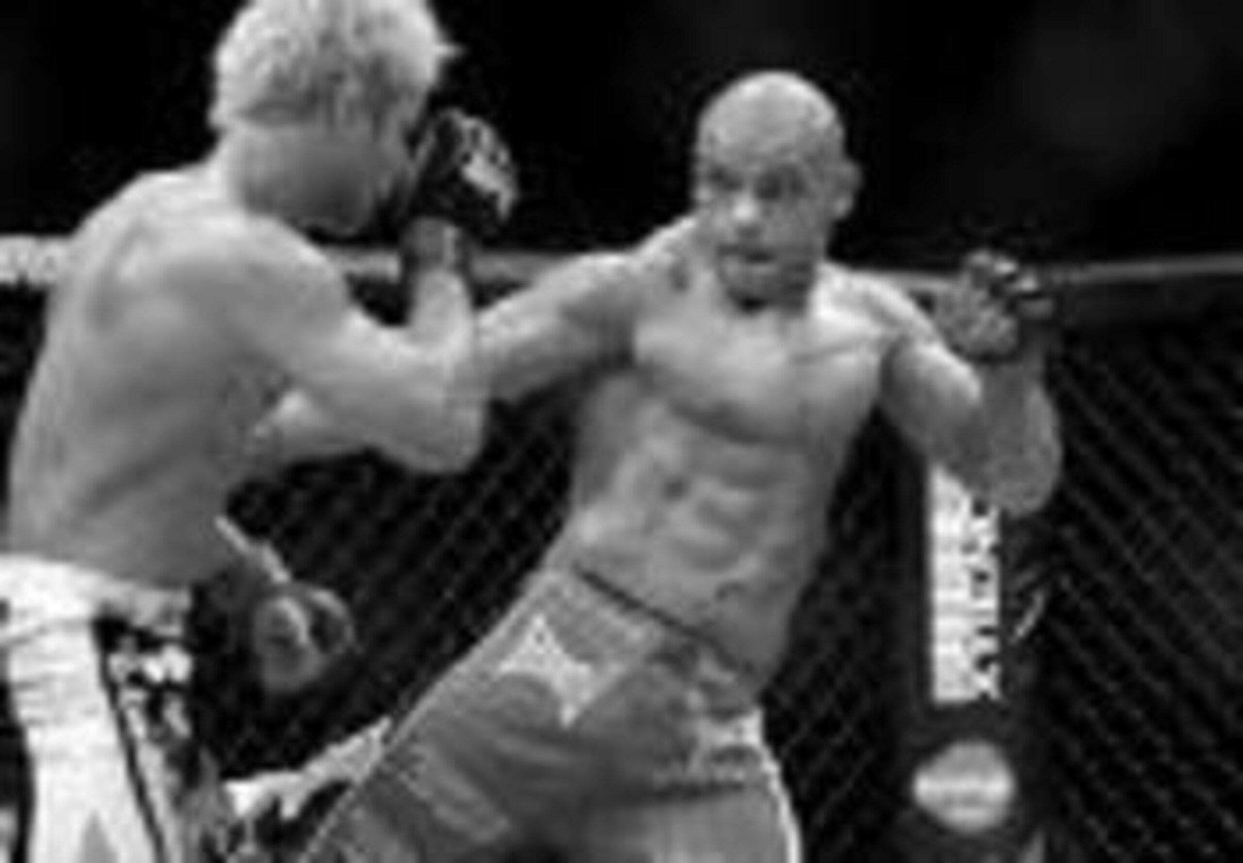 Thiago Alves landing a leg kick on Josh Koscheck