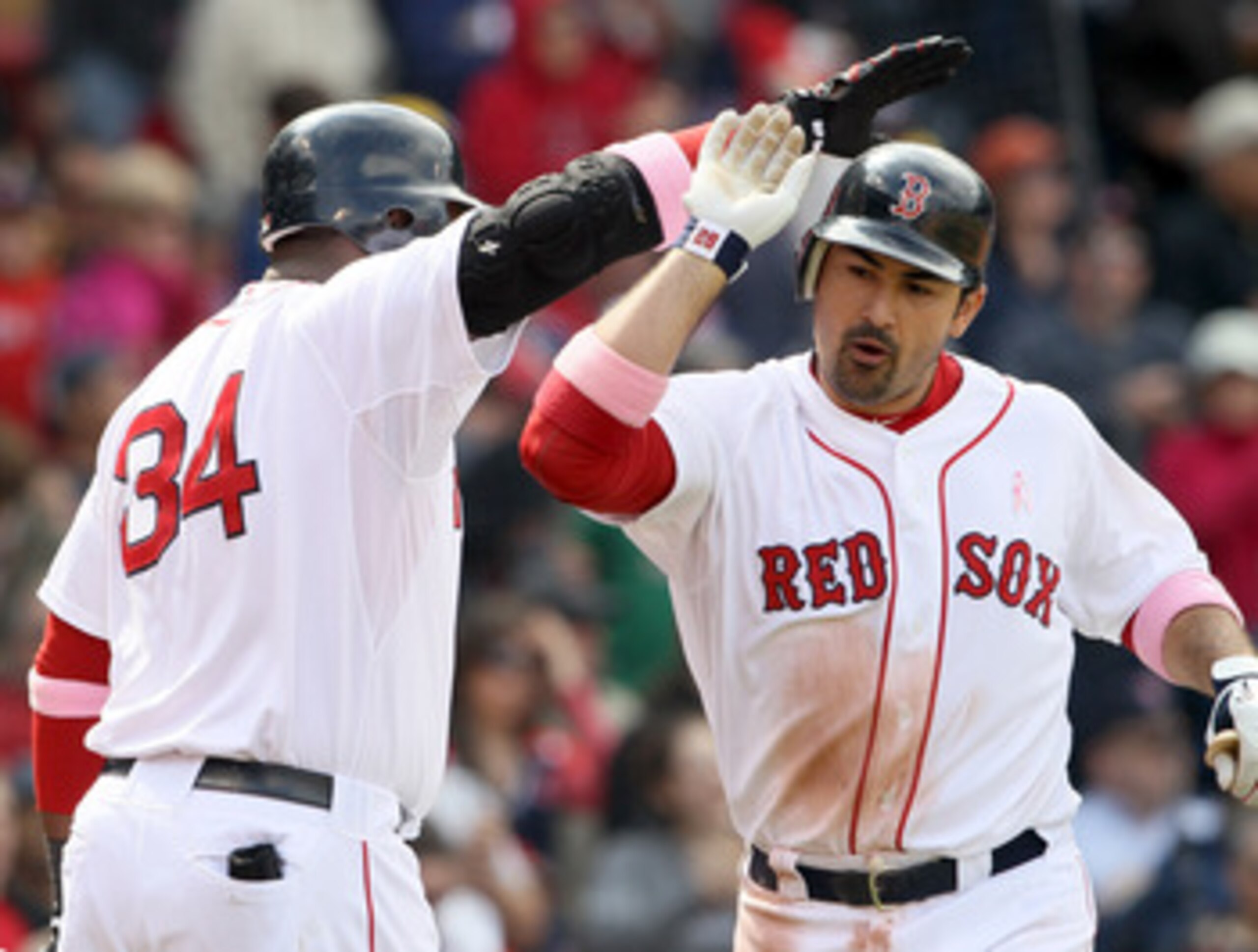BOSTON, MA - MAY 08: Adrian Gonzalez #28 is congratulated by teammate David Ortiz #34 of the Boston Red Sox after Gonzalez hit a solo home run in the fifth inning against the Minnesota Twins on May 8, 2011 at Fenway Park in Boston, Massachusetts. (Photo BOSTON, MA - MAY 08: Adrian Gonzalez #28 is congratulated by teammate David Ortiz #34 of the Boston Red Sox after Gonzalez hit a solo home run in the fifth inning against the Minnesota Twins on May 8, 2011 at Fenway Park in Boston, Massachusetts. (Photo