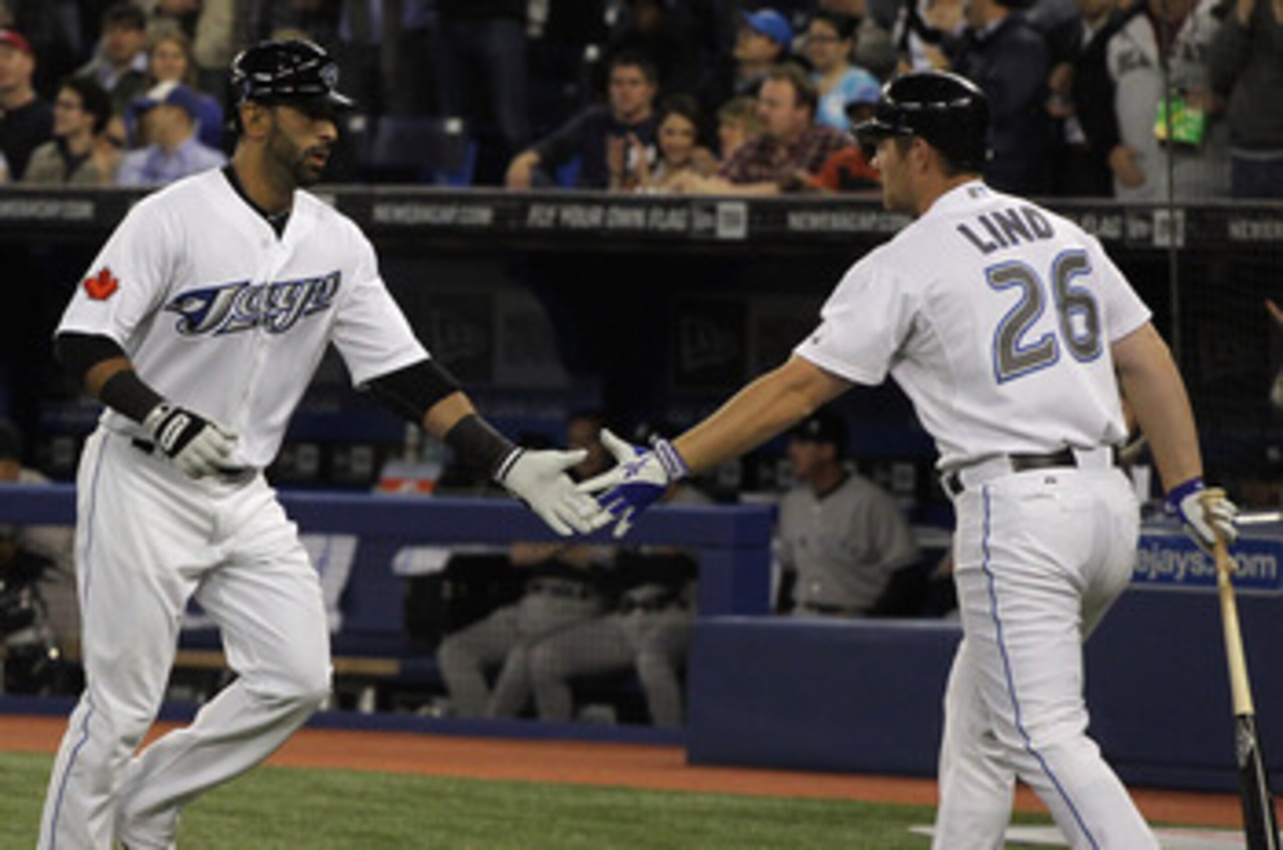 TORONTO, ON - APRIL 19: Jose Bautista #19 (L) of the Toronto Blue Jays celebrates with teammate Adam Lind #26 after Bautista's first inning home run during their game against the New York Yankees at Rogers Centre on April 19, 2011 in Toronto, Canada. (P TORONTO, ON - APRIL 19: Jose Bautista #19 (L) of the Toronto Blue Jays celebrates with teammate Adam Lind #26 after Bautista's first inning home run during their game against the New York Yankees at Rogers Centre on April 19, 2011 in Toronto, Canada. (P