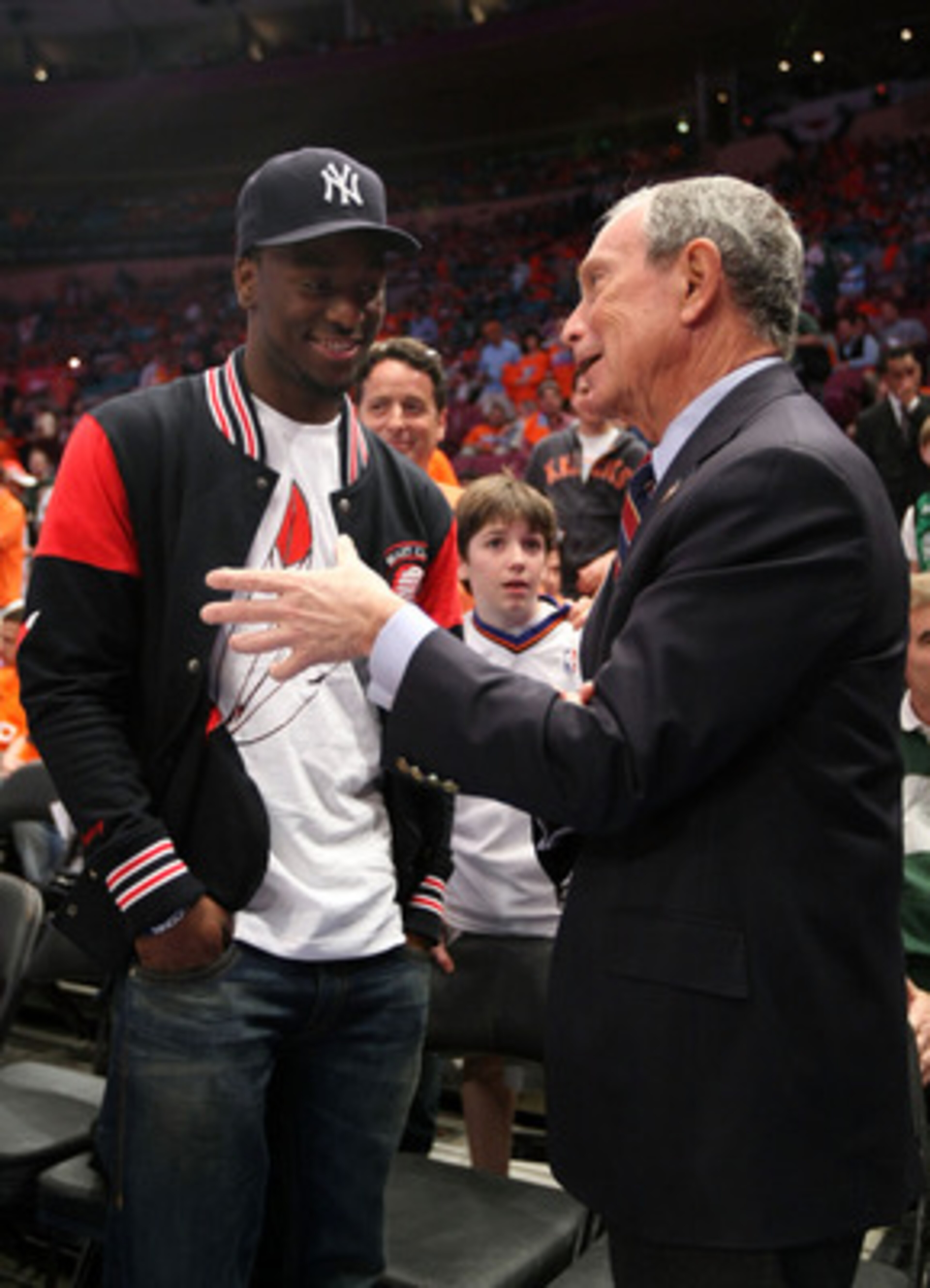 NEW YORK, NY - APRIL 24:  NBA draft prospect Kemba Walker (L) from the University of Connecticut Huskies and New York City Mayor Michael Bloomberg watch the New York Knicks play against the Boston Celtics in Game Four of the Eastern Conference Quarterfina