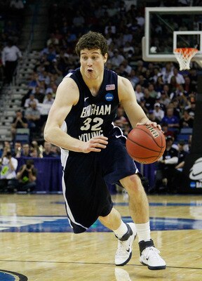 NEW ORLEANS, LA - MARCH 24:  Jimmer Fredette #32 of the Brigham Young Cougars drives past Kenny Boynton #1 of the Florida Gators during the Southeast regional of the 2011 NCAA men's basketball tournament at New Orleans Arena on March 24, 2011 in New Orlea