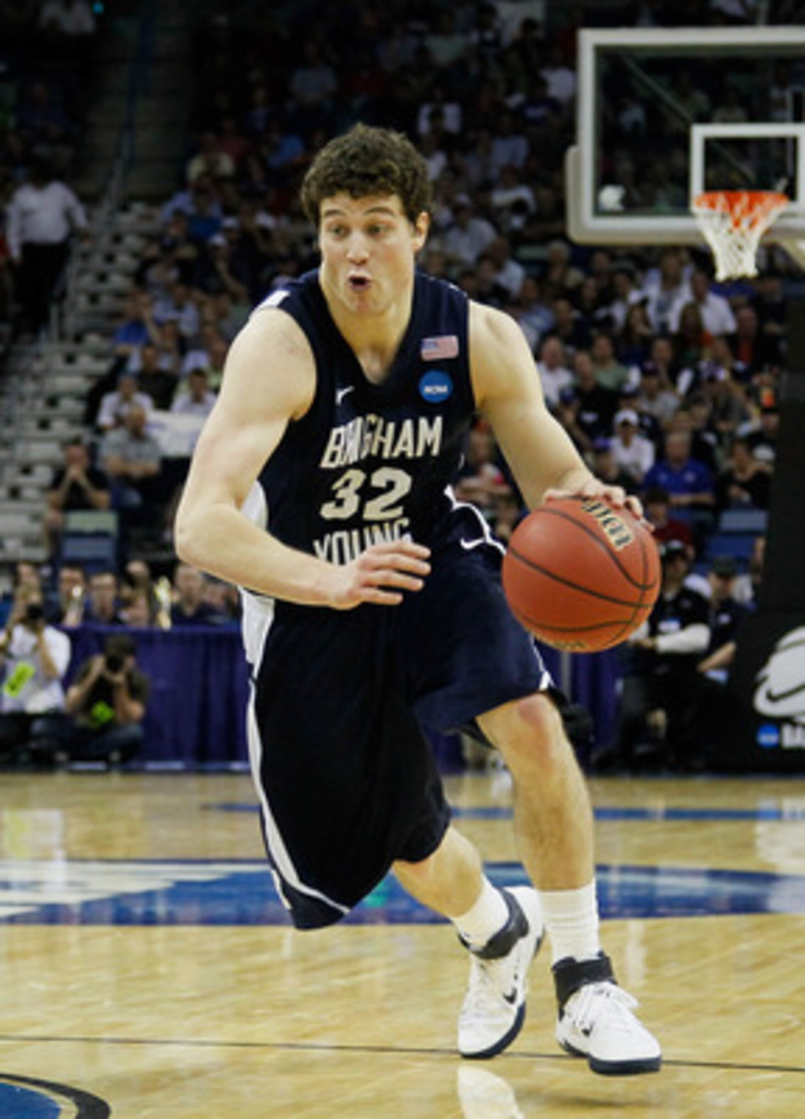 NEW ORLEANS, LA - MARCH 24:  Jimmer Fredette #32 of the Brigham Young Cougars drives past Kenny Boynton #1 of the Florida Gators during the Southeast regional of the 2011 NCAA men's basketball tournament at New Orleans Arena on March 24, 2011 in New Orlea