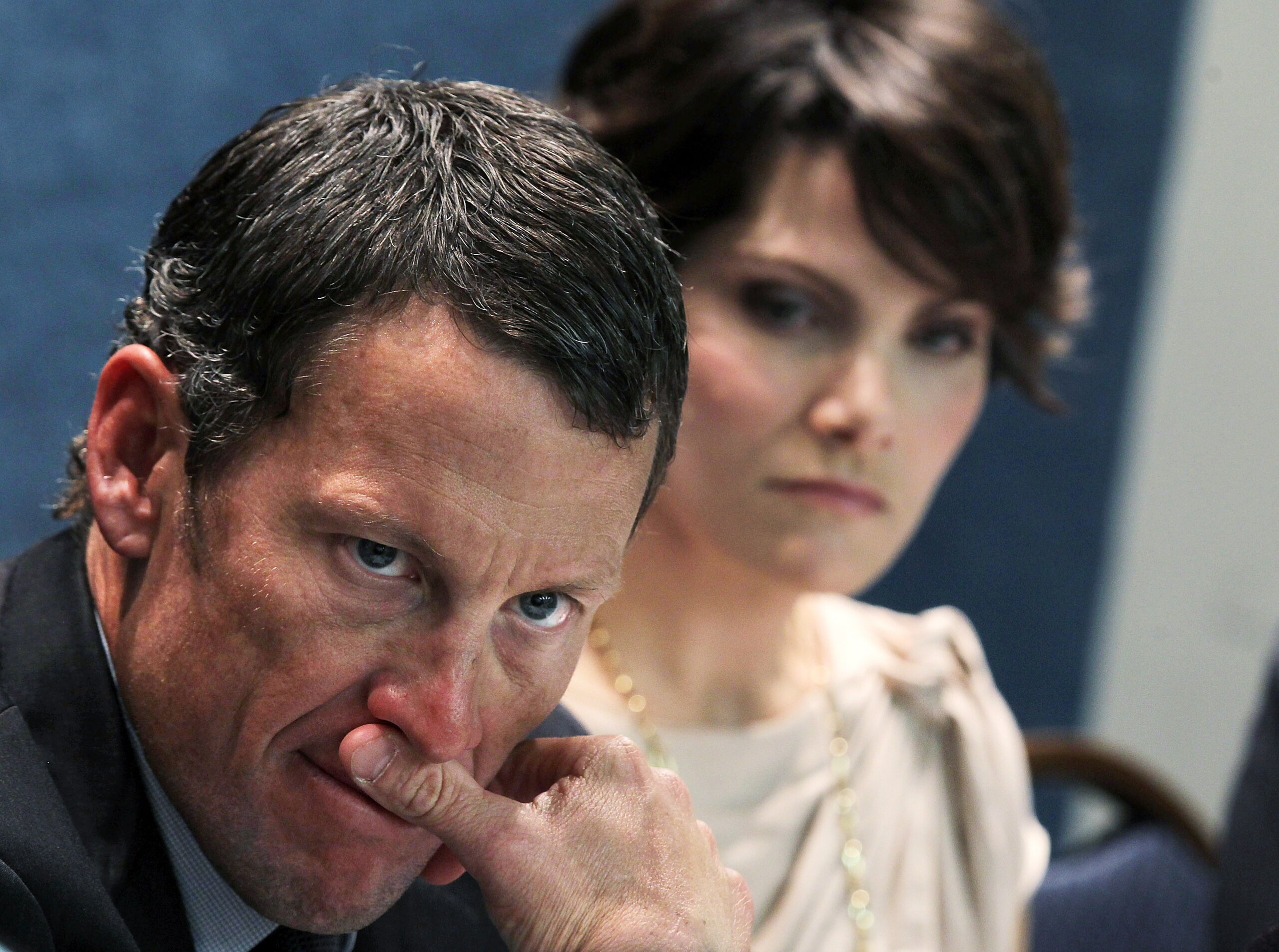 WASHINGTON, DC - MARCH 24:  LIVESTRONG Founder and Chairman and seven-time Tour de France champion Lance Armstrong (L) and cancer survivor Tracy Elliman (R) of Kennett Square, Pennsylvania, listen during a news conference at the National Press Club March