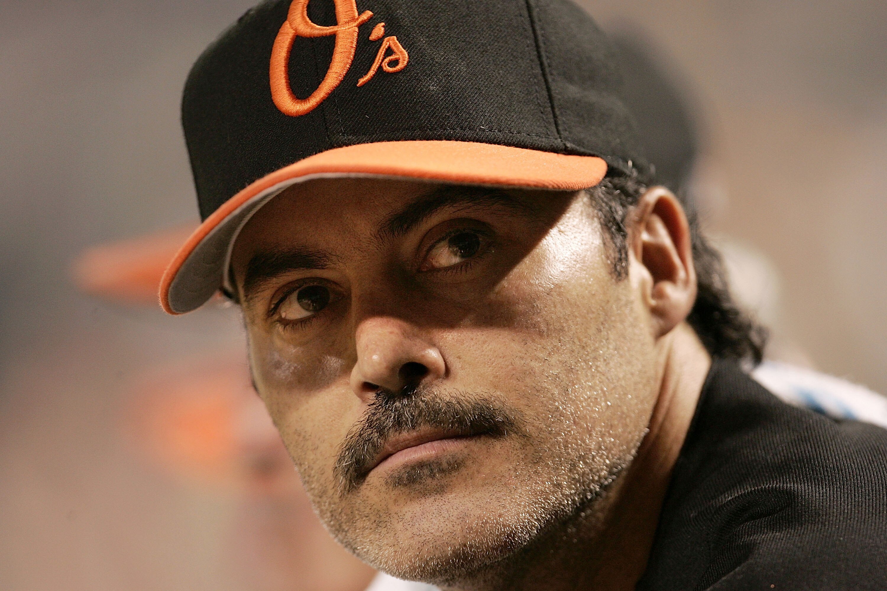 BALTIMORE - AUGUST 12:  Rafael Palmeiro #25 of the Baltimore Orioles watches from the dugout as his team plays against the Toronto Blue Jays August 12, 2005 at Oriole Park at Camden Yards in Baltimore, Maryland. Palmeiro was named in the Mitchell Report t