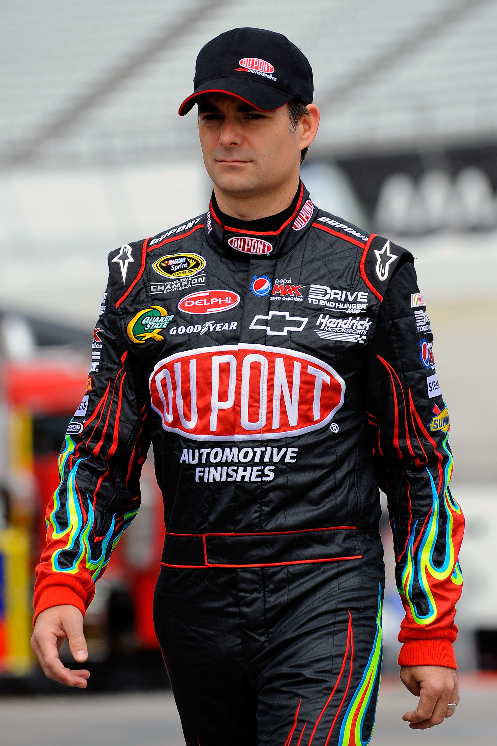 DOVER, DE - MAY 13:  Jeff Gordon, driver of the #24 DuPont Chevrolet, walks in the garage area during practice for the NASCAR Sprint Cup Series FedEx 400 Benefiting Autism Speaks at Dover International Speedway on May 13, 2011 in Dover, Delaware.  (Photo