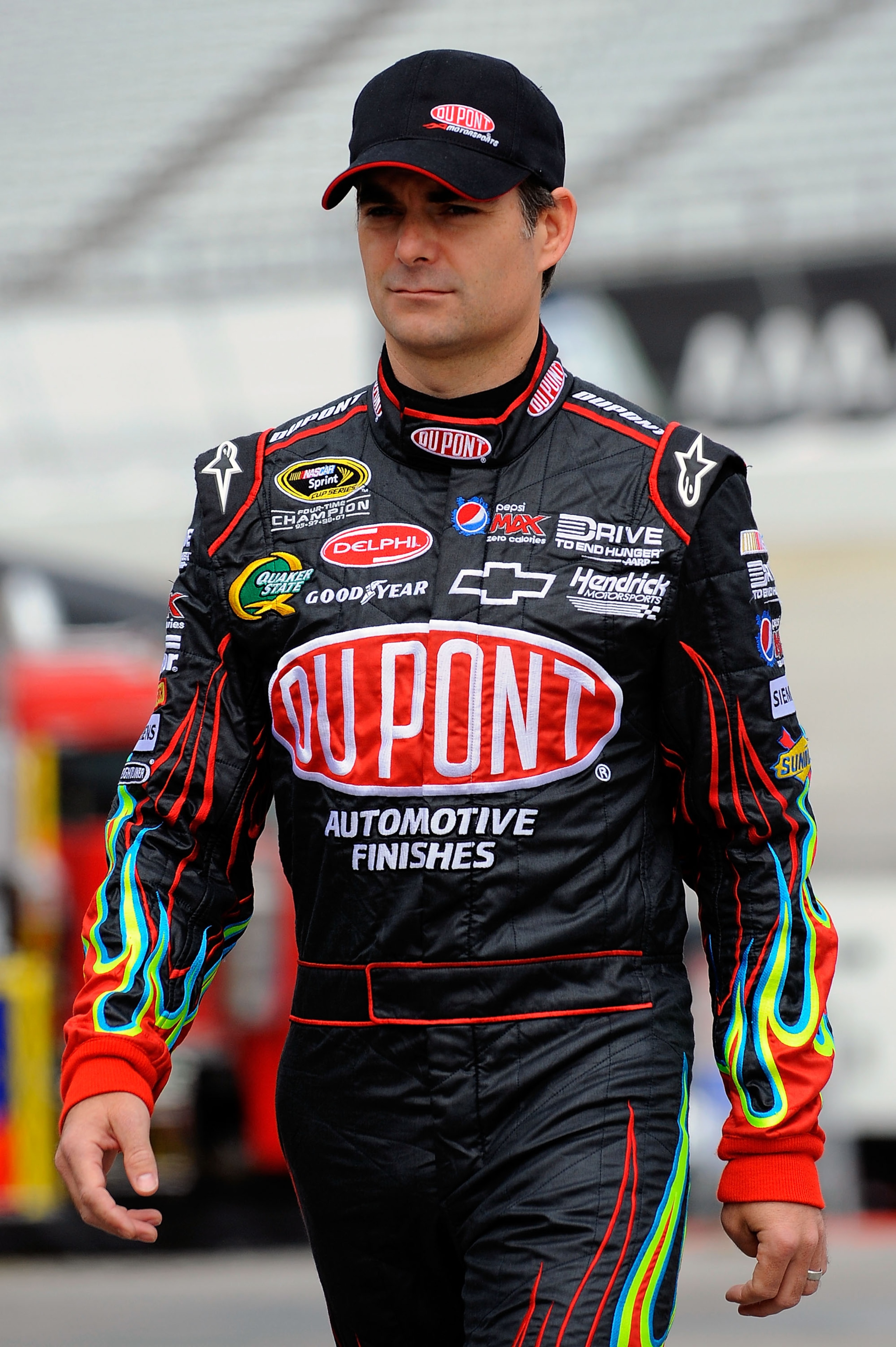 DOVER, DE - MAY 13:  Jeff Gordon, driver of the #24 DuPont Chevrolet, walks in the garage area during practice for the NASCAR Sprint Cup Series FedEx 400 Benefiting Autism Speaks at Dover International Speedway on May 13, 2011 in Dover, Delaware.  (Photo