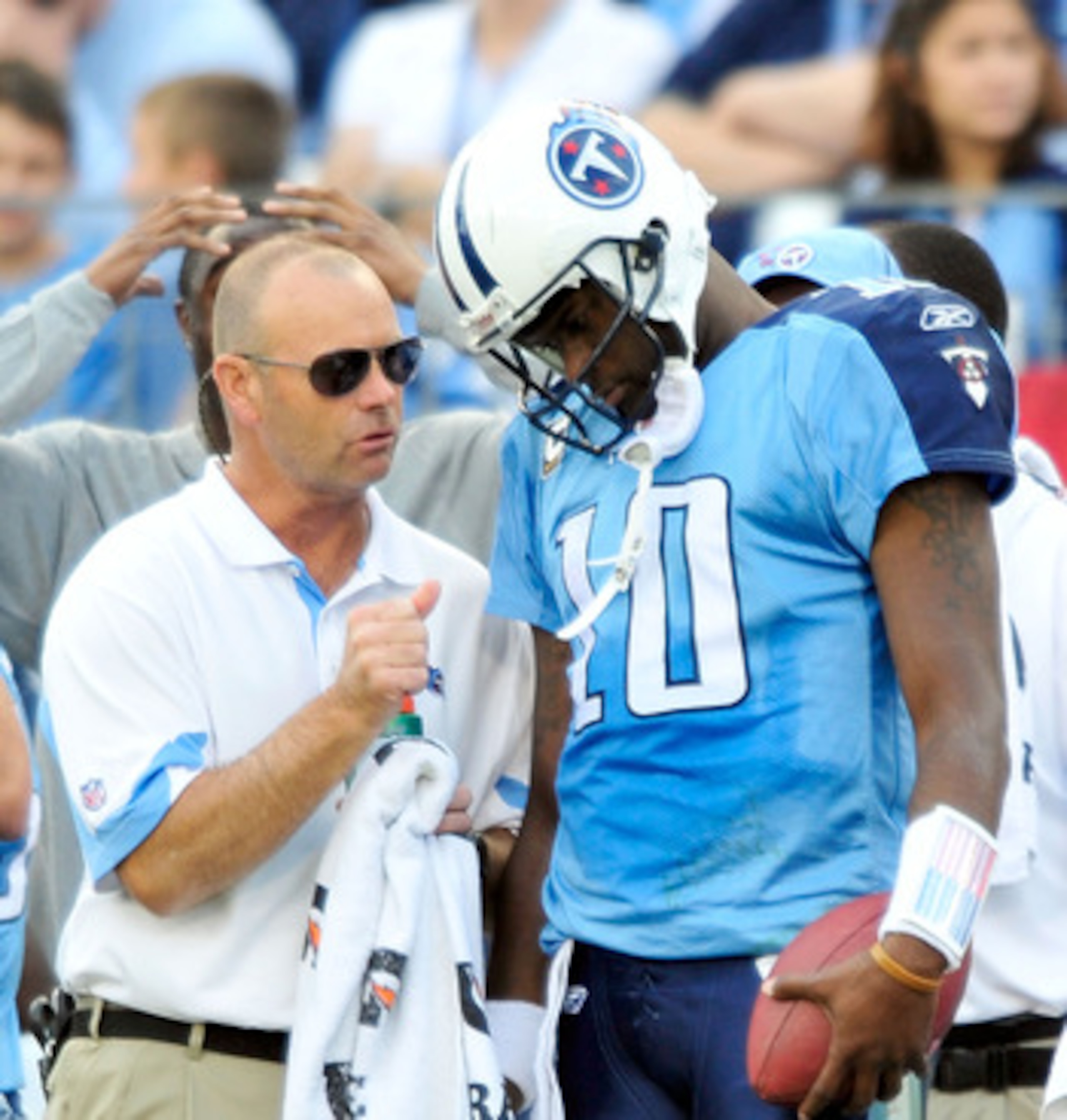 NASHVILLE, TN - NOVEMBER 21:  Quarterback Vince Young #11 of the Tennessee Titans talks with a member of the training staff after leaving a game against the Washington Redskins at LP Field on November 21, 2010 in Nashville, Tennessee. The Redskins won 19-