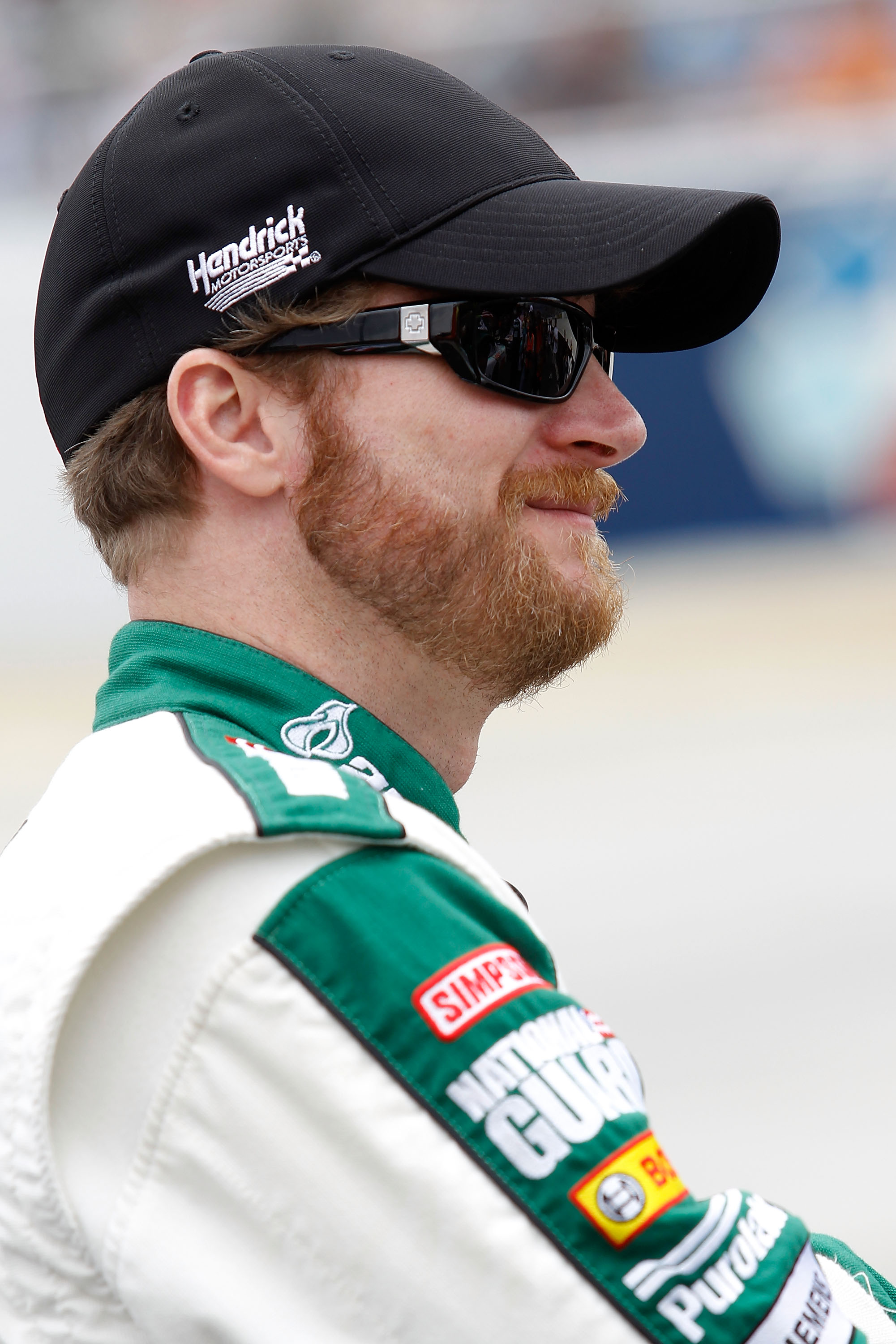 DOVER, DE - MAY 15:  Dale Earnhardt Jr., driver of the #88 Amp Energy Sugar Free/National Guard Chevrolet, stands on the grid prior to the NASCAR Sprint Cup Series FedEx 400 Benefiting Autism Speaks at Dover International Speedway on May 15, 2011 in Dover